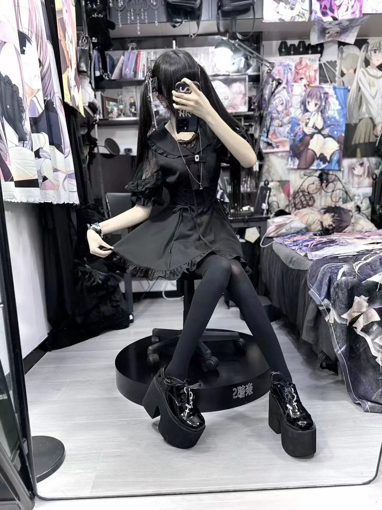 Black Jirai Kei dress with platform boots and ruffled skirt hem worn side mirror view sitting pose