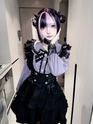 Purple long-sleeve jirai kei blouse with black lace details and corset waistband worn with devil hair horns close-up mirror selfie