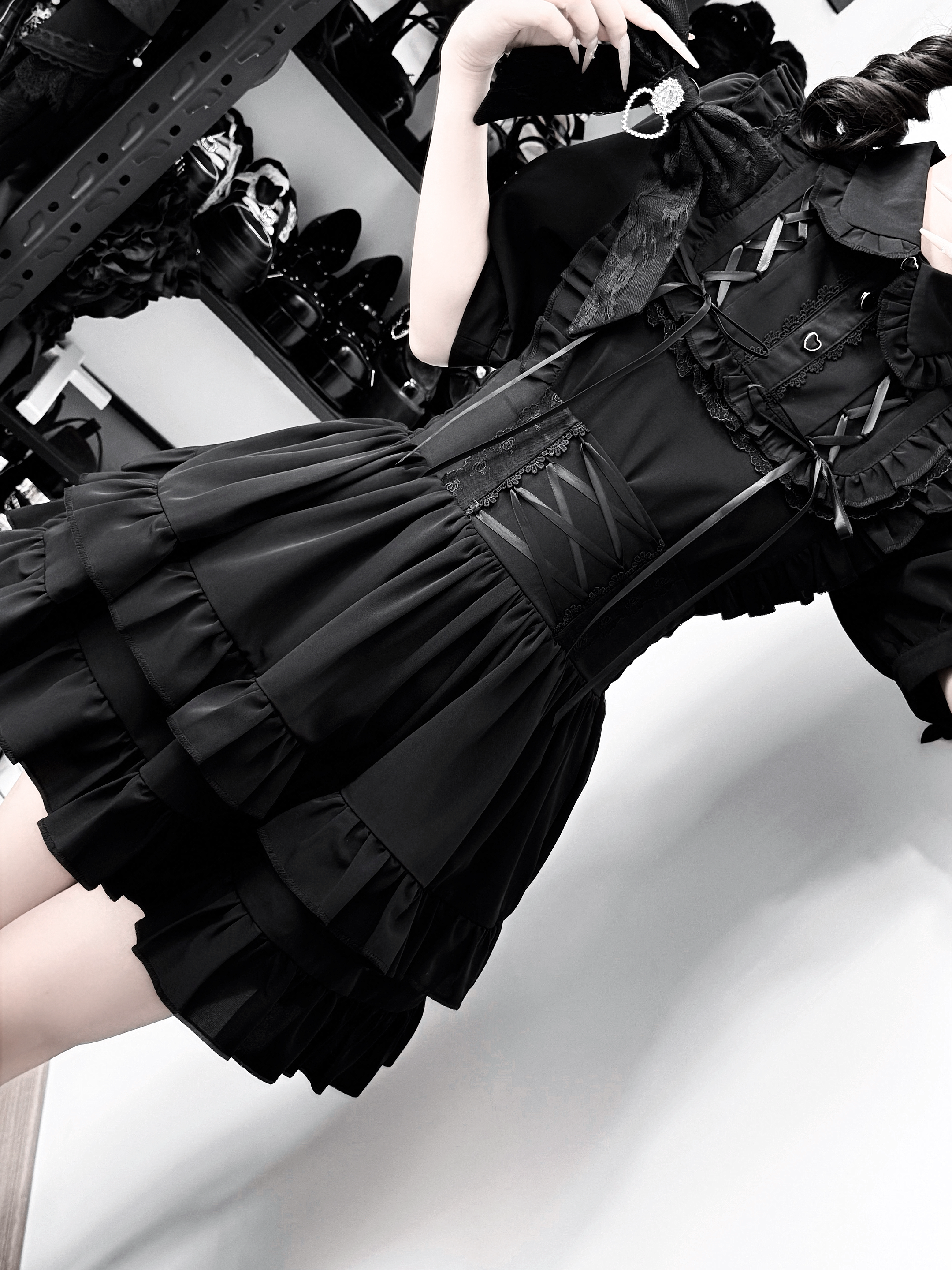 Jirai Kei black outfit low angle side shot displaying corset lace-up waist and tiered ruffle hem construction