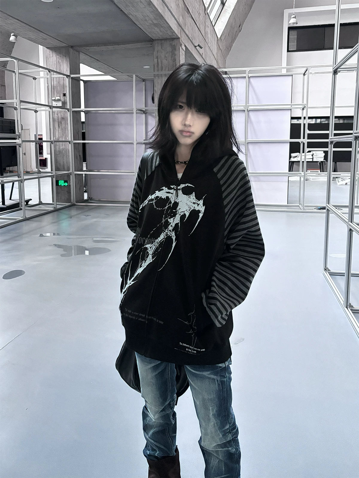 Hooded scythe print zip coat detail shot showing zipper hardware cross design and pocket placement dark streetwear construction