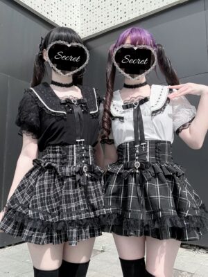 Black and white Jirai Kei sailor collar blouse with lace puff sleeves and detachable heart bow front full-body outdoor shot two models
