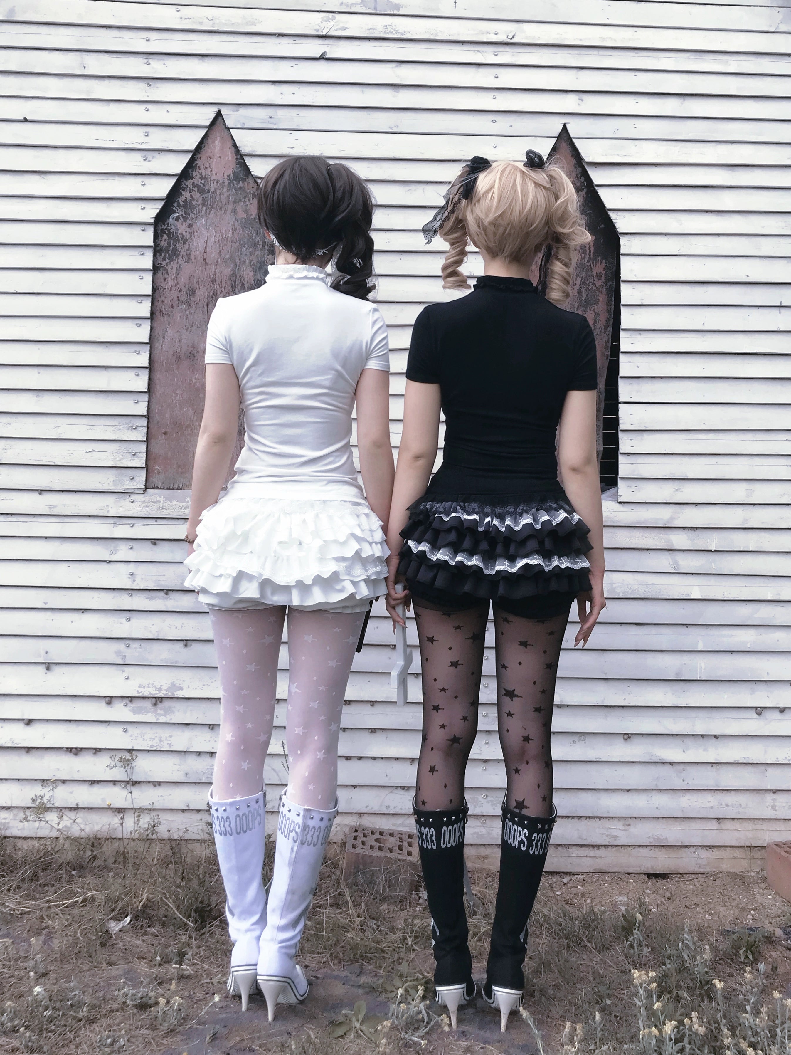 White gothic doll top with sheer tulle overlay and cross embellishments lace trim detail close-up