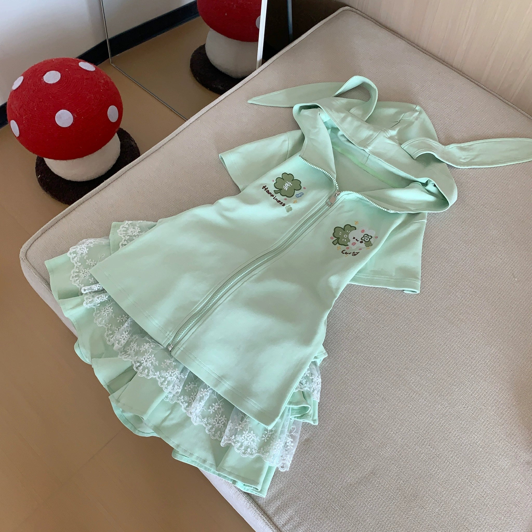 Back view of mint green Jirai Kei tiered lace ruffle skirt showing layered ruffle hem design, lace paneling details, and fitted hip silhouette construction