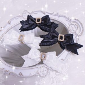 Black and white bow hair clips collection displayed on vintage carved vanity mirror with sparkly starry aesthetic showing square gem and pearl decorative centers
