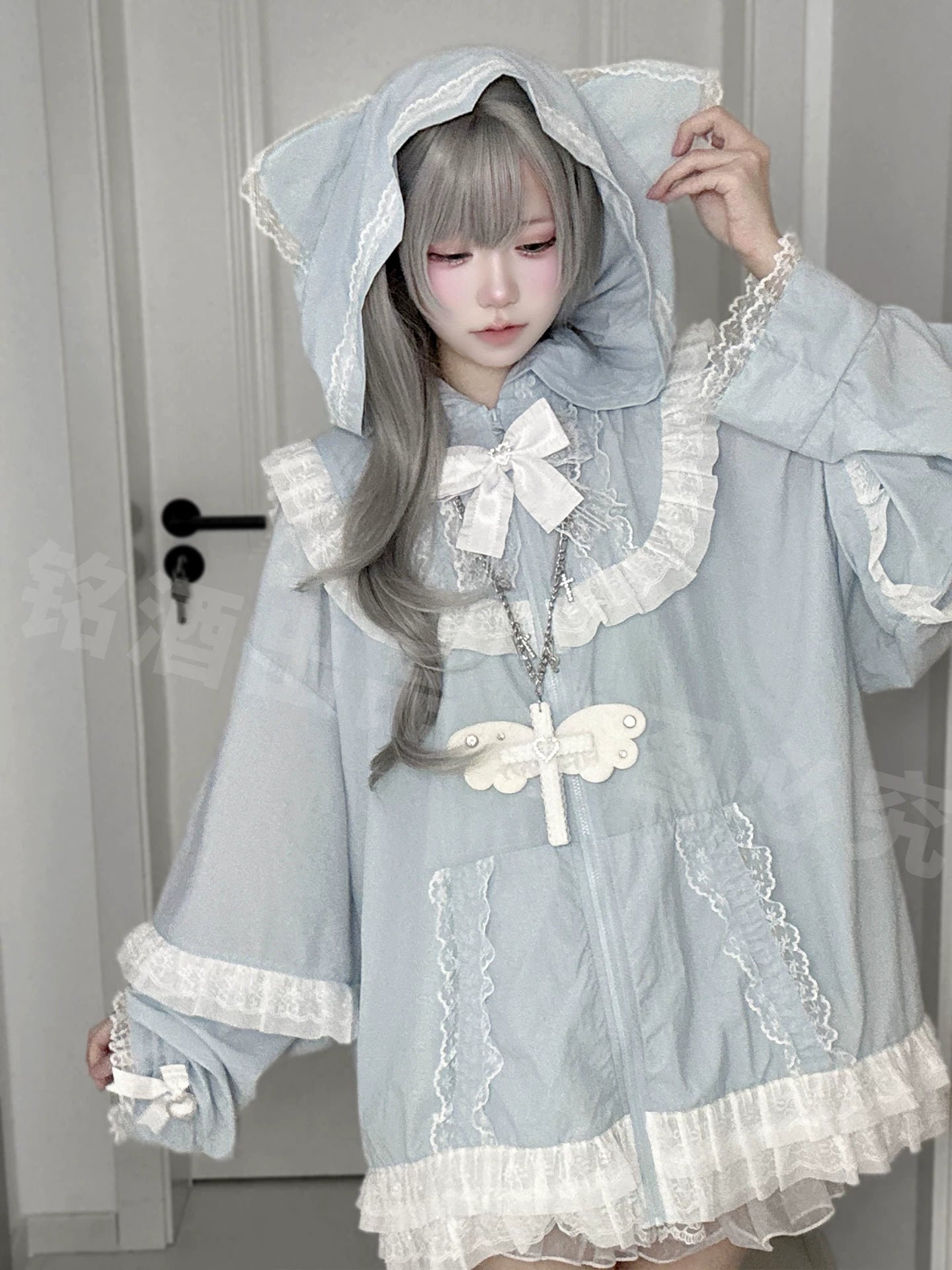 Light blue water-blue cat-ear sun jacket on mannequin front view with bow collar and dragonfly pendant styling