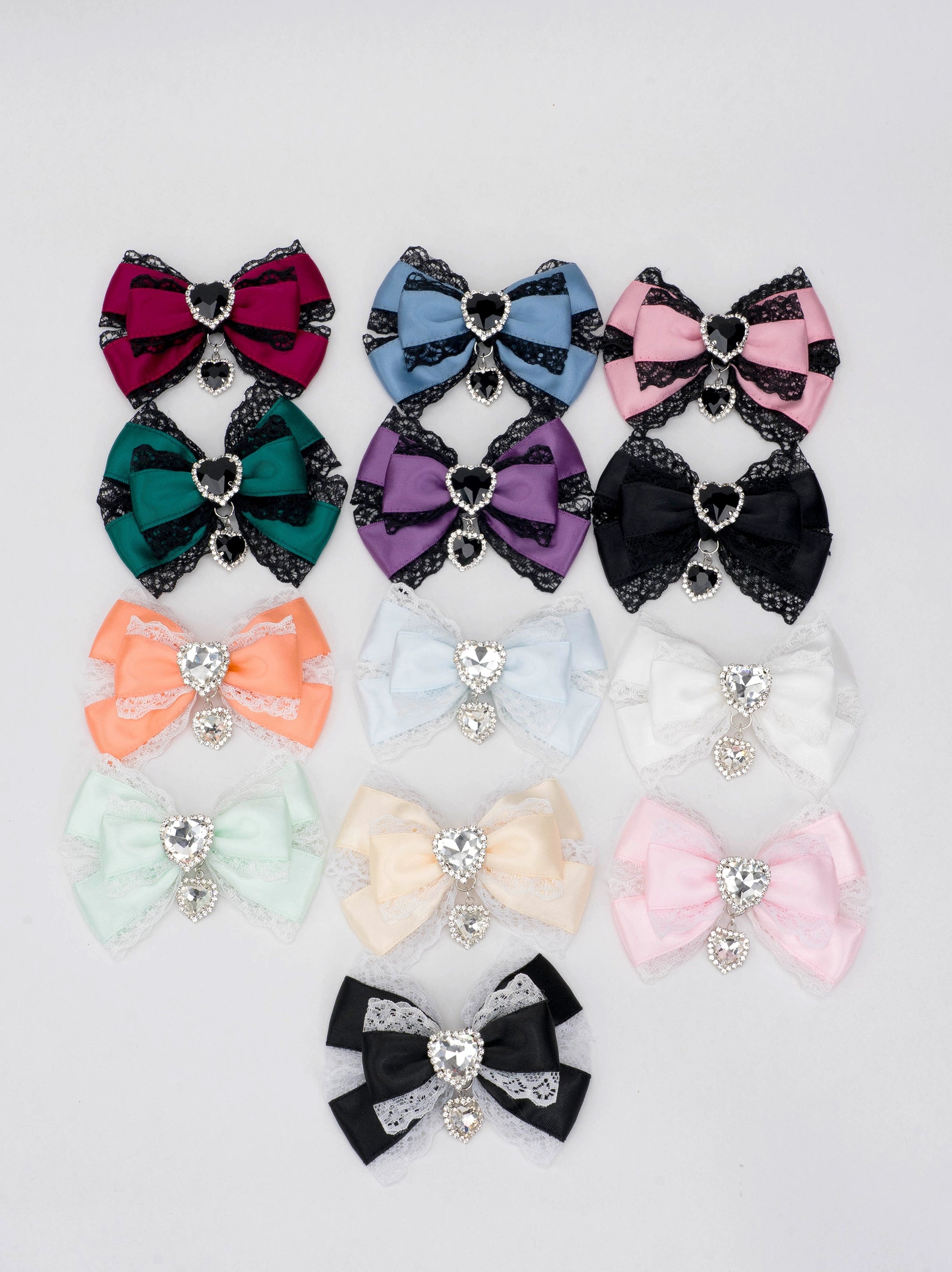 13-color jirai kei lace rhinestone bow hair clip collection flat lay overhead view multiple color variants