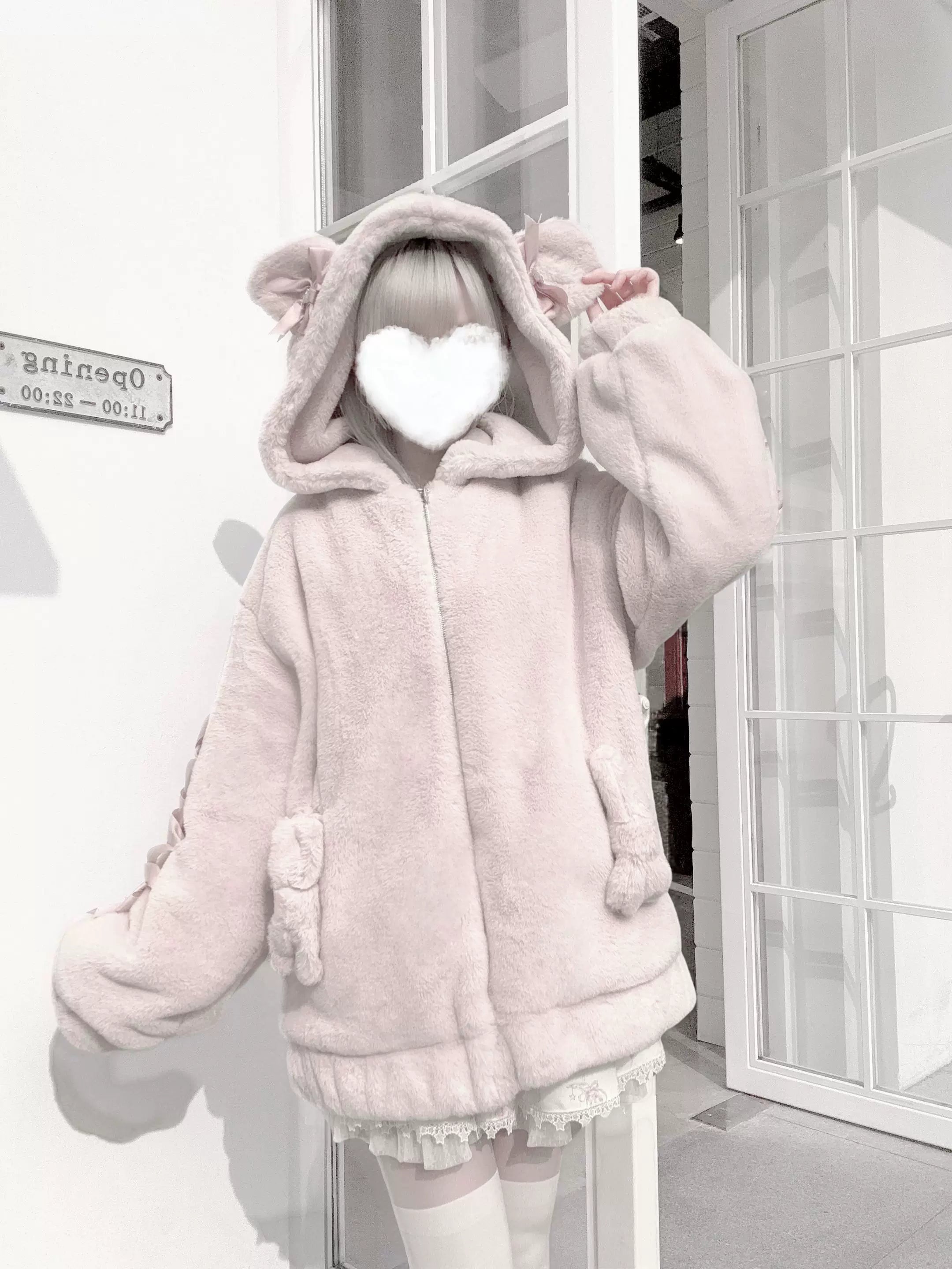 Front view of pink Ryousangata bear ear coat with ruffle sleeve bows worn over lolita dress displaying subcultural aesthetic