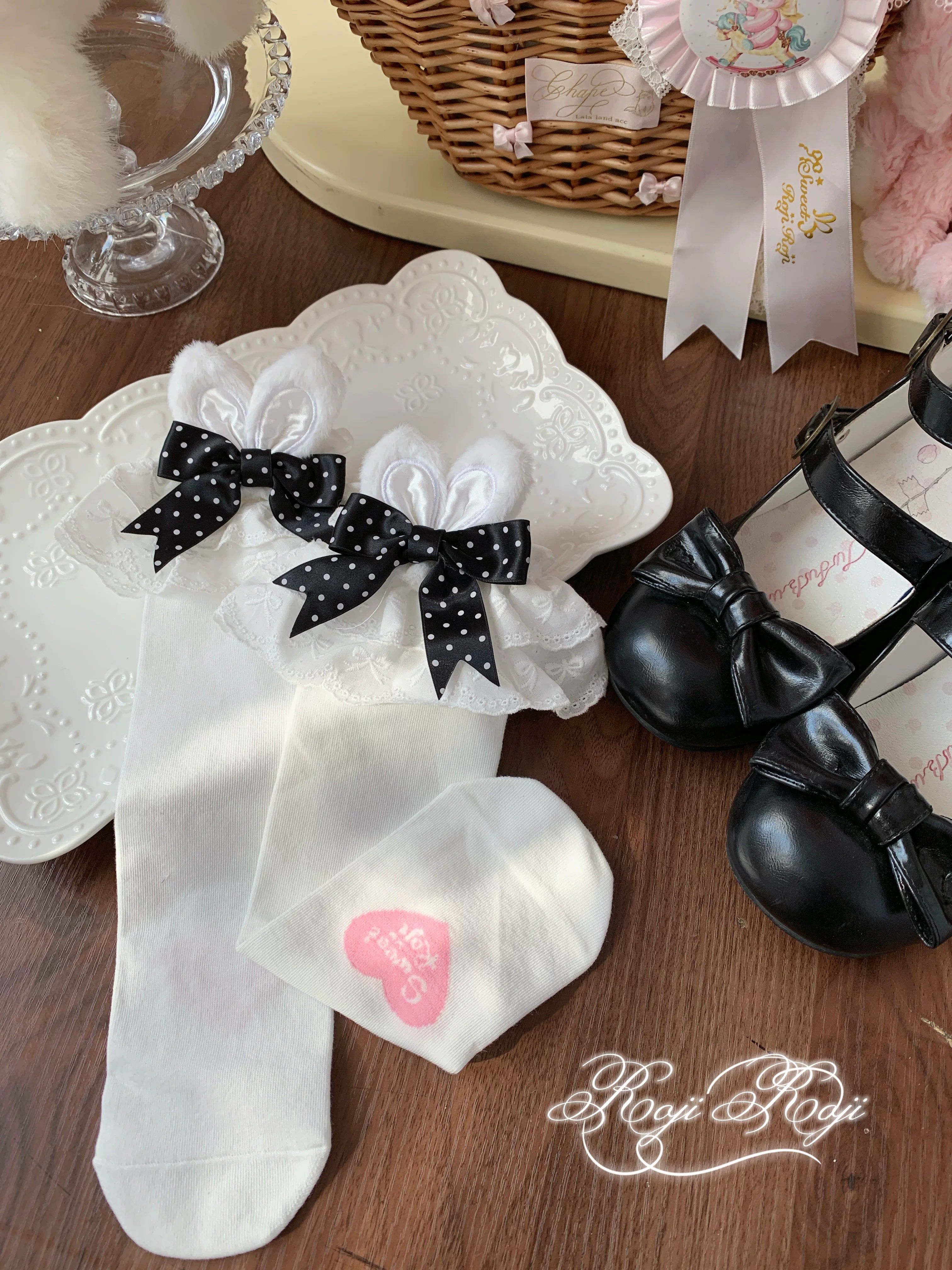 Jirai Kei black polka dot bunny ear socks with white base and gothic Lolita coordinate styling in specialty shop setting