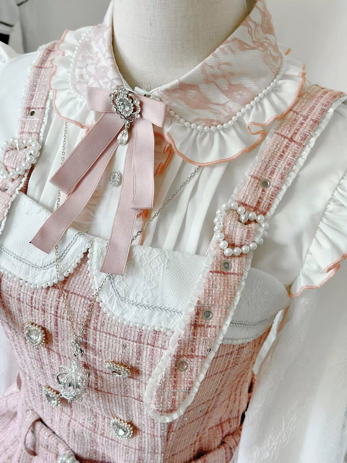 Close-up front view Jirai Kei blouse with pink overall pink bow brooch pearl-studded strap pink collar trim