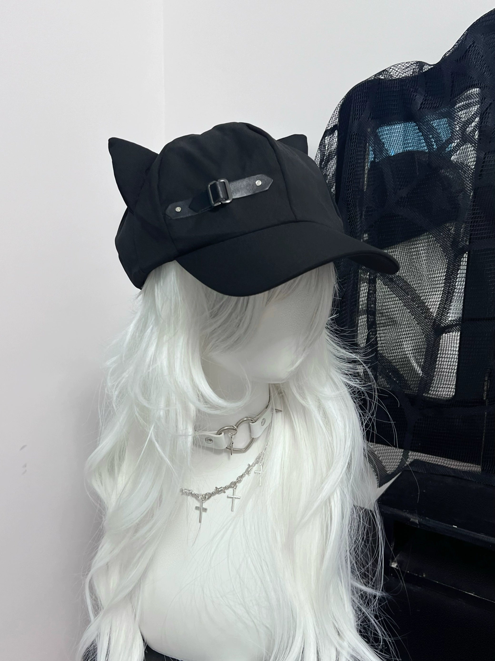 Black cat ear peaked cap side front right angle view, leather buckle fastener detail, gothic mannequin styling, Jirai Kei accessory angle shot