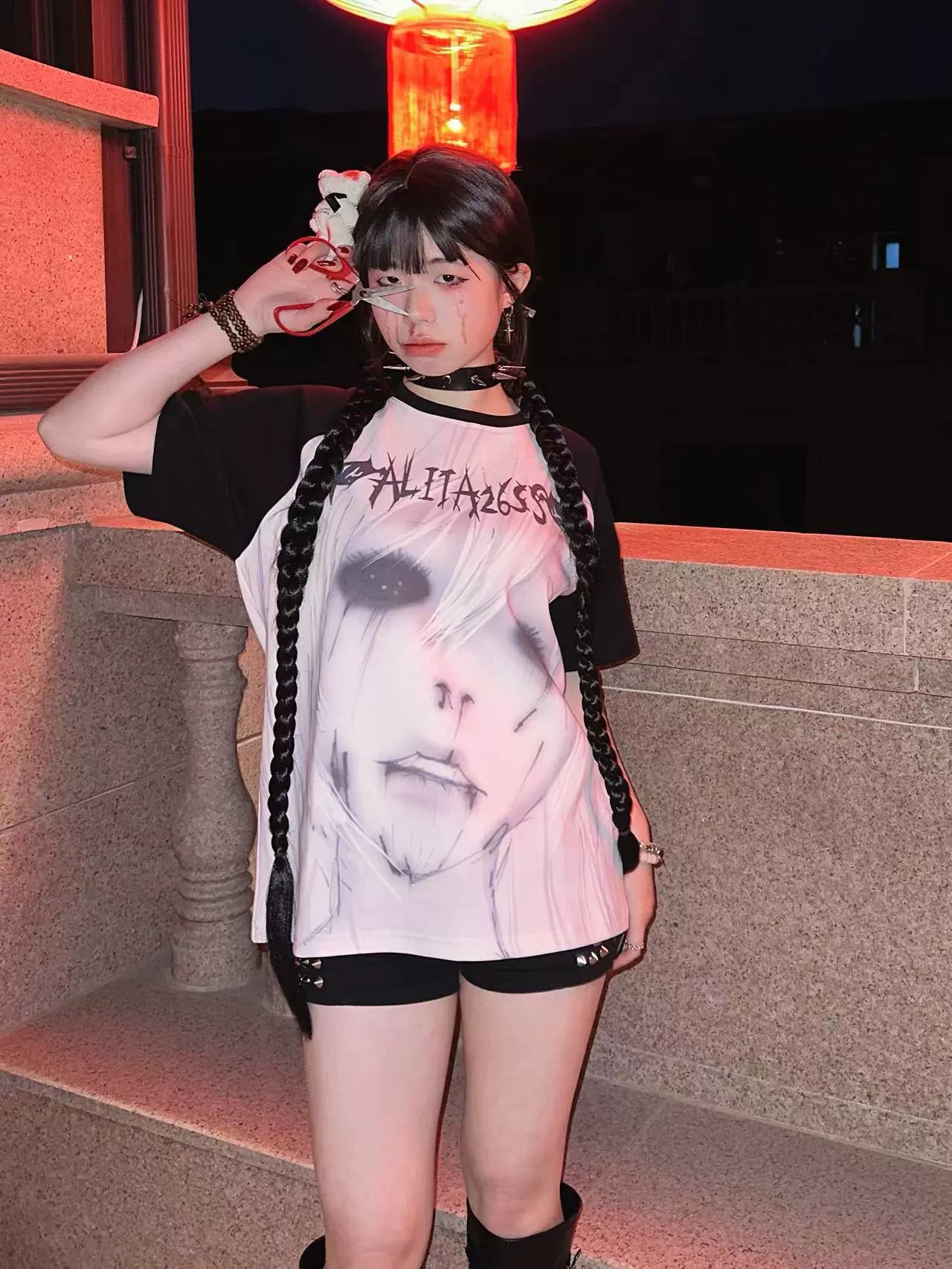 Side front angle of Jirai Kei ALITA26SS printed raglan T-shirt with loose fit and black contrast short sleeves on model