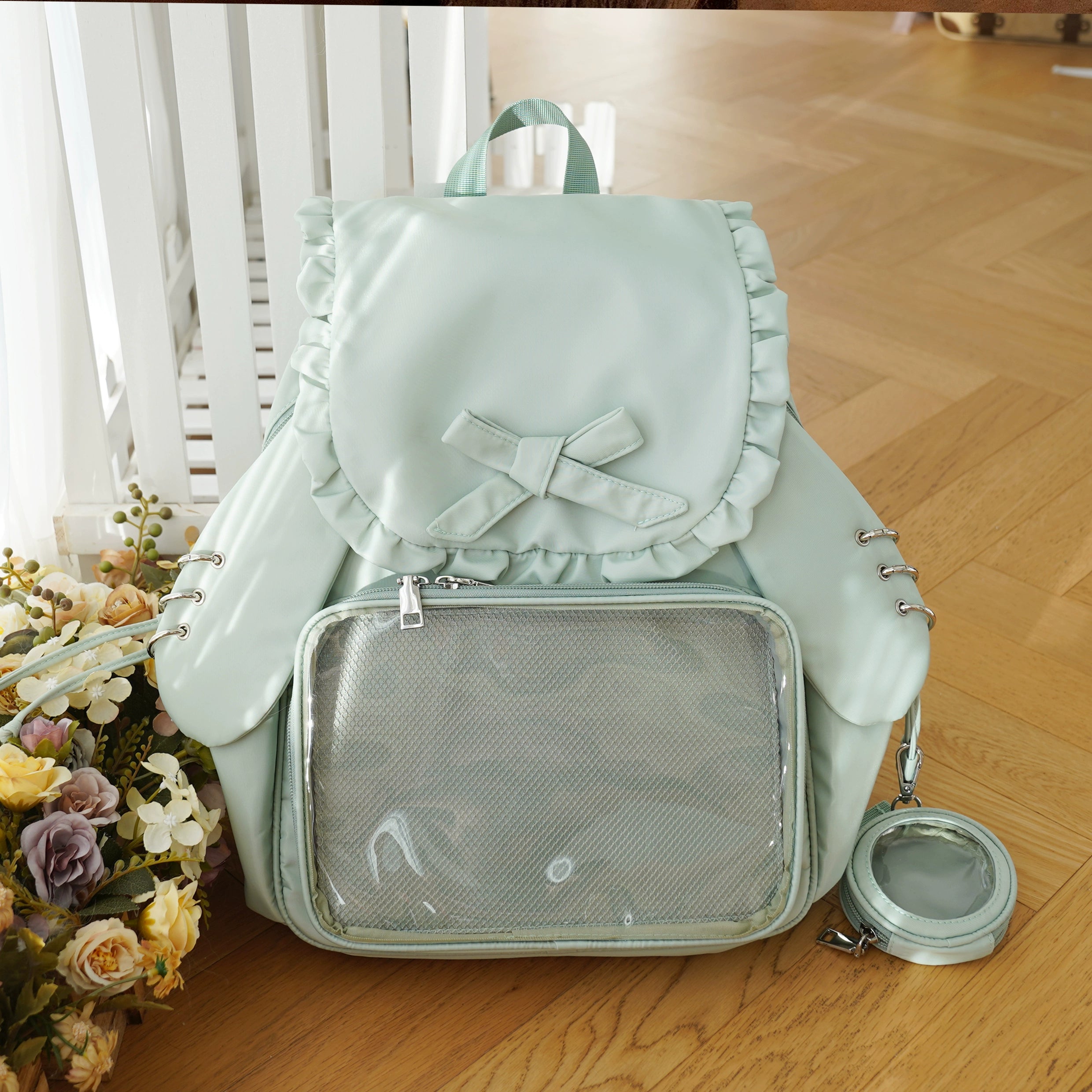 Mint green Jirai Kei itabag backpack featuring cute detachable bunny ears, transparent badge showcase window, ruffled trim, and green mini bag