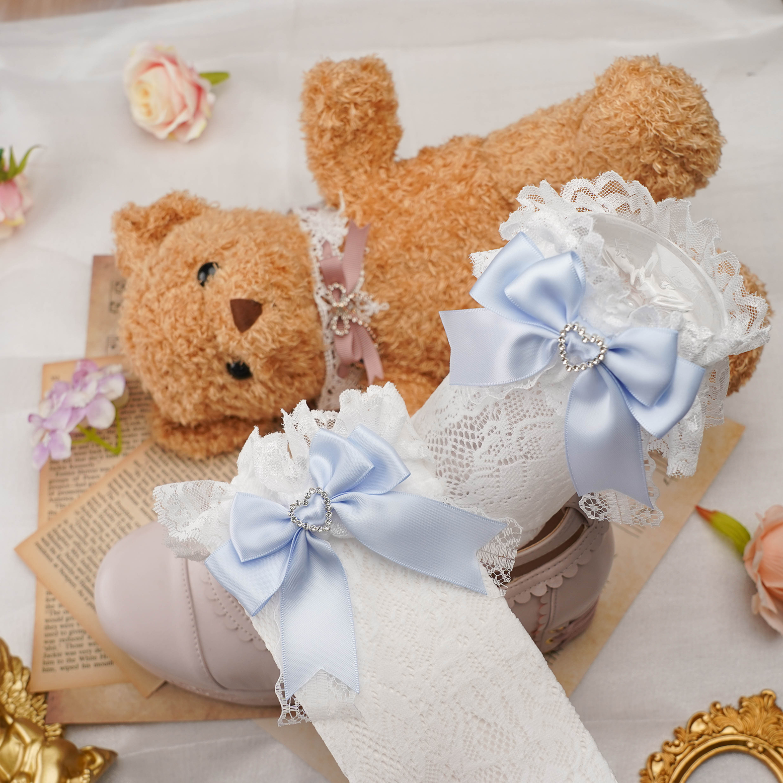 Jirai kei lace ankle socks featuring heart rhinestone accents and colorful satin bow details displayed in aesthetic flat lay composition