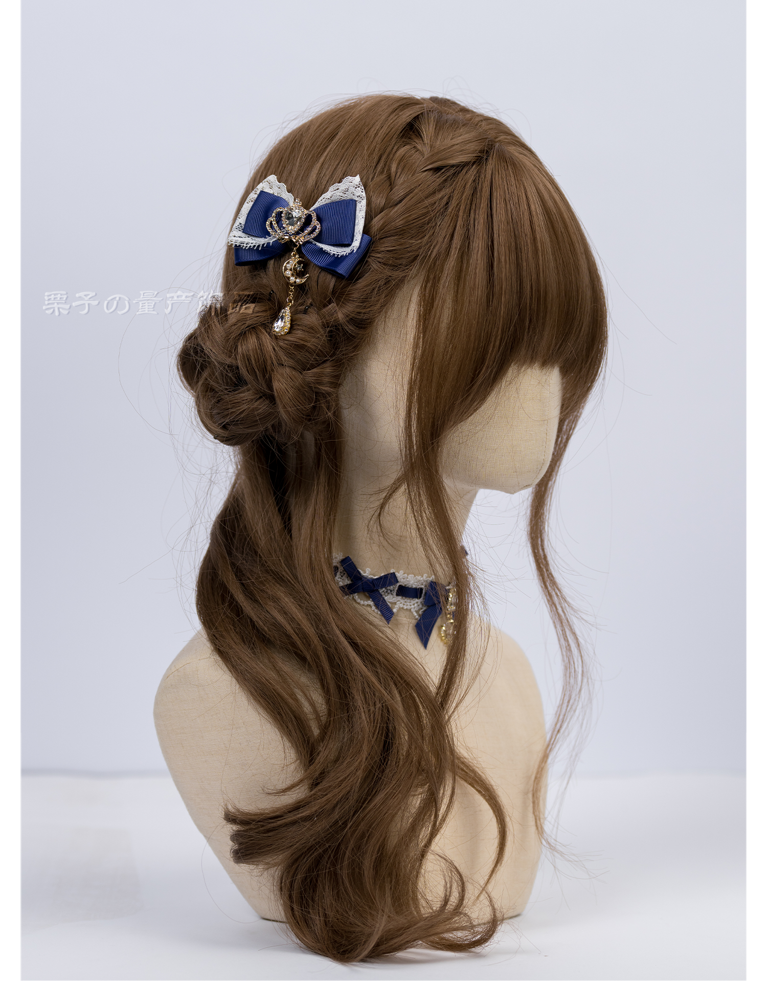 Jirai Kei navy blue bow hair clip with dangling metal charm side profile on curly mannequin wig