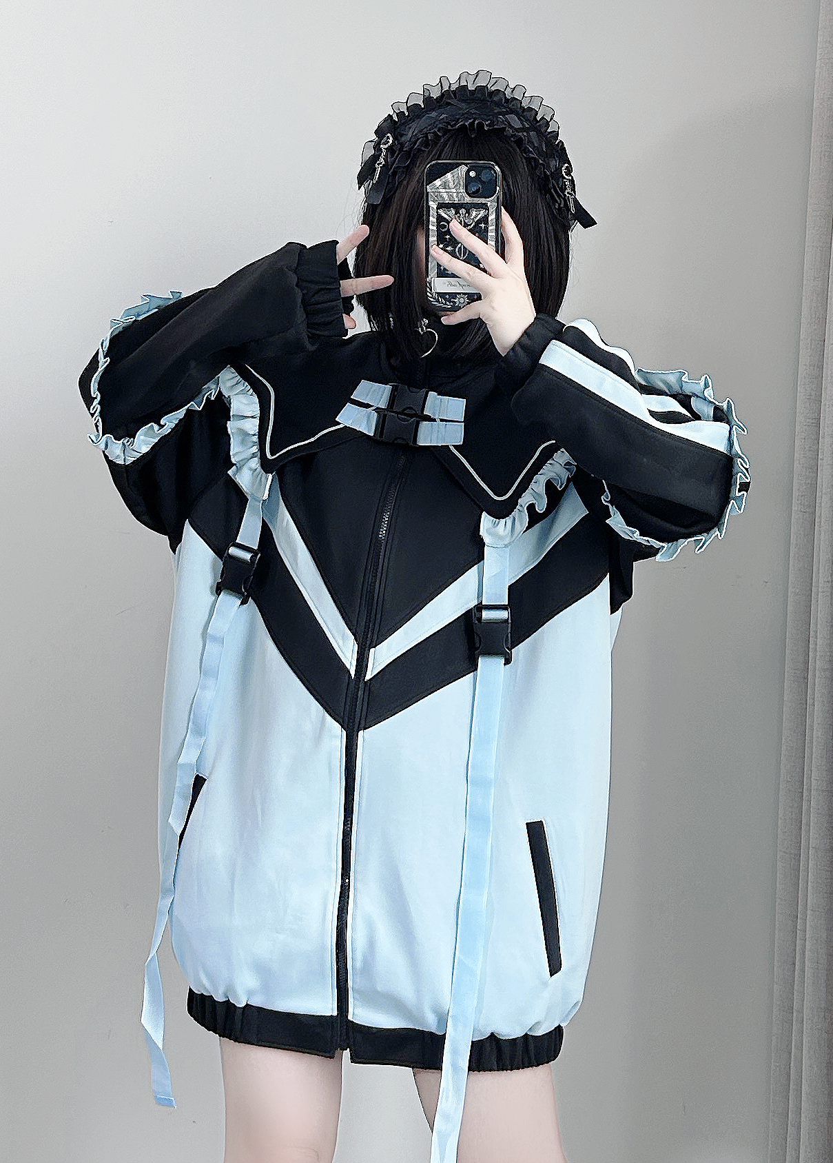Black and light blue Tenshi Kaiwai color block jacket with chevron pattern and buckle collar trim, ruffled long sleeves, mirror front selfie with lace headband