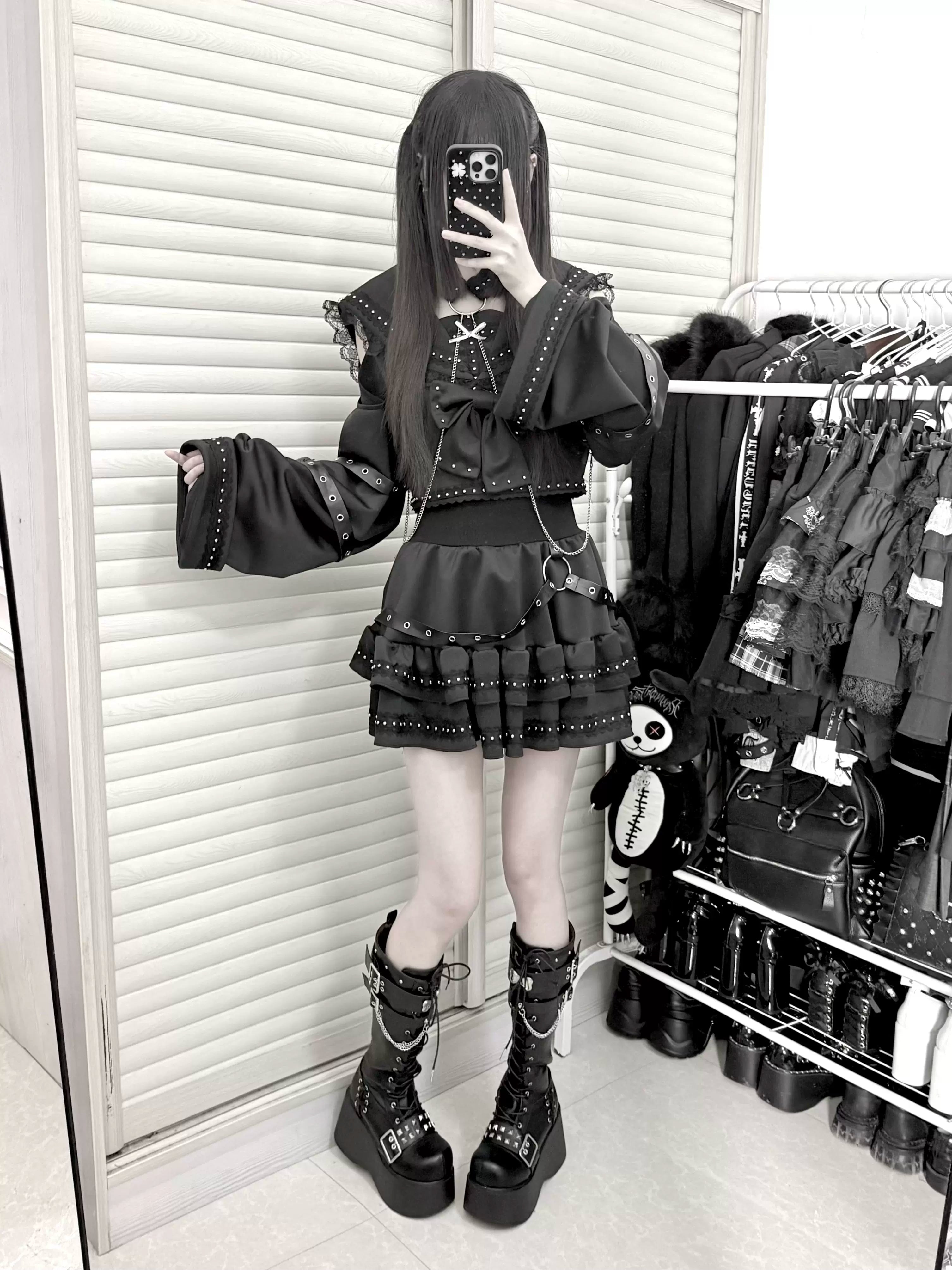 Black gothic sailor top and skirt set mirror selfie shot in clothing shop showing platform boots ruffled skirt bell sleeves complete styling