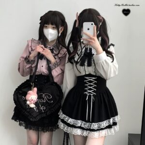 Full-body front view of jirai kei high-waist lace-up skirt with double-layer lace hem paired with pink ruffled blouse showing complete outfit styling