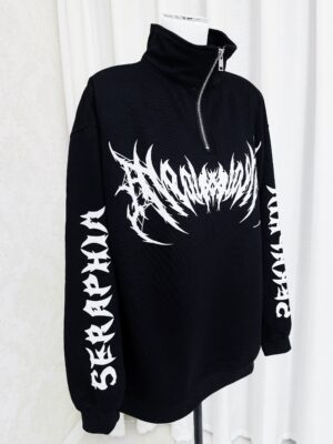 Jirai Kei gothic black and white half-zip sweatshirt front view on display mannequin, showing bold graphic print and oversized silhouette with dropped shoulders