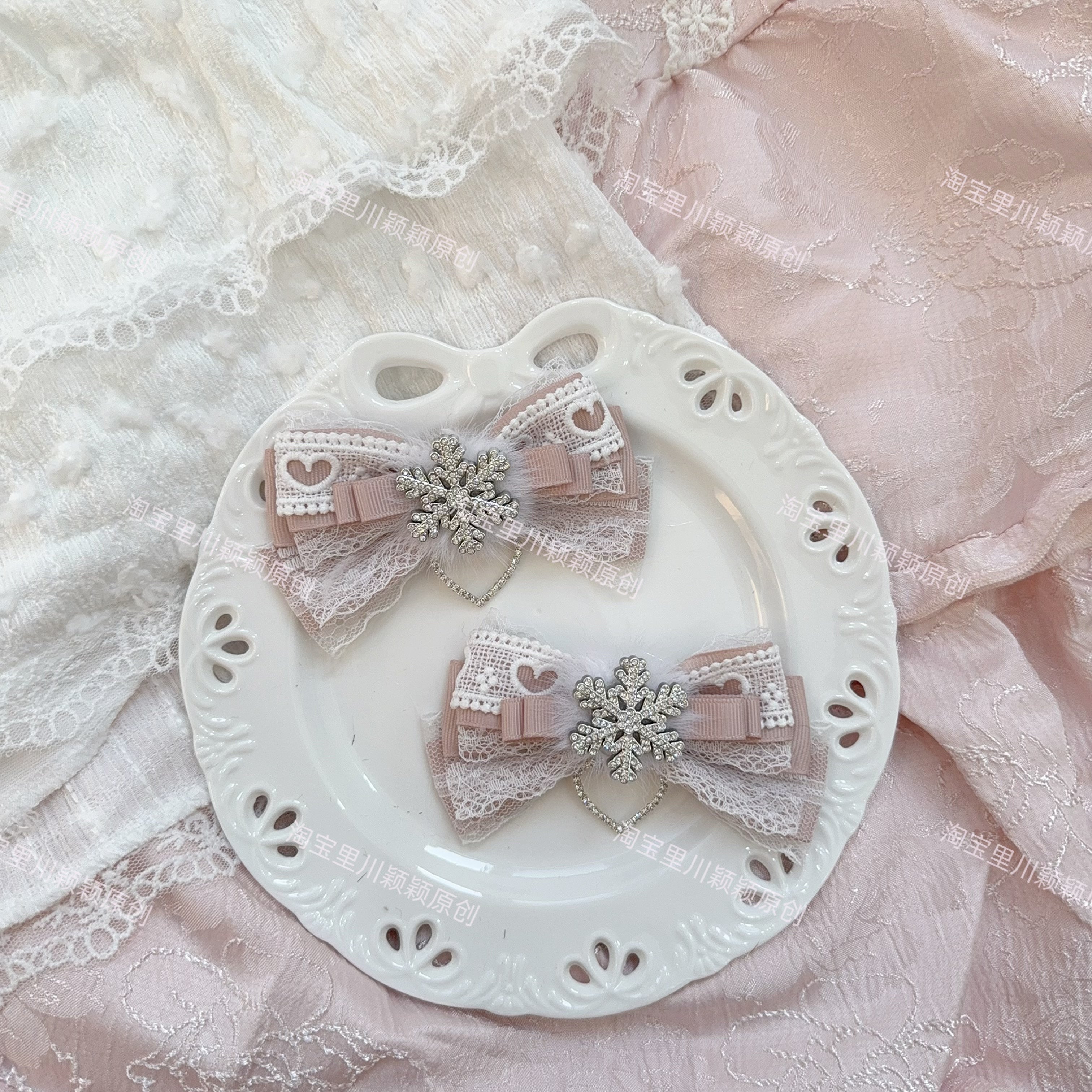 Light dusty pink Jirai Kei bow hair clips with soft lace trim silver snowflake embellishment romantic gentle femininity aesthetic flat lay