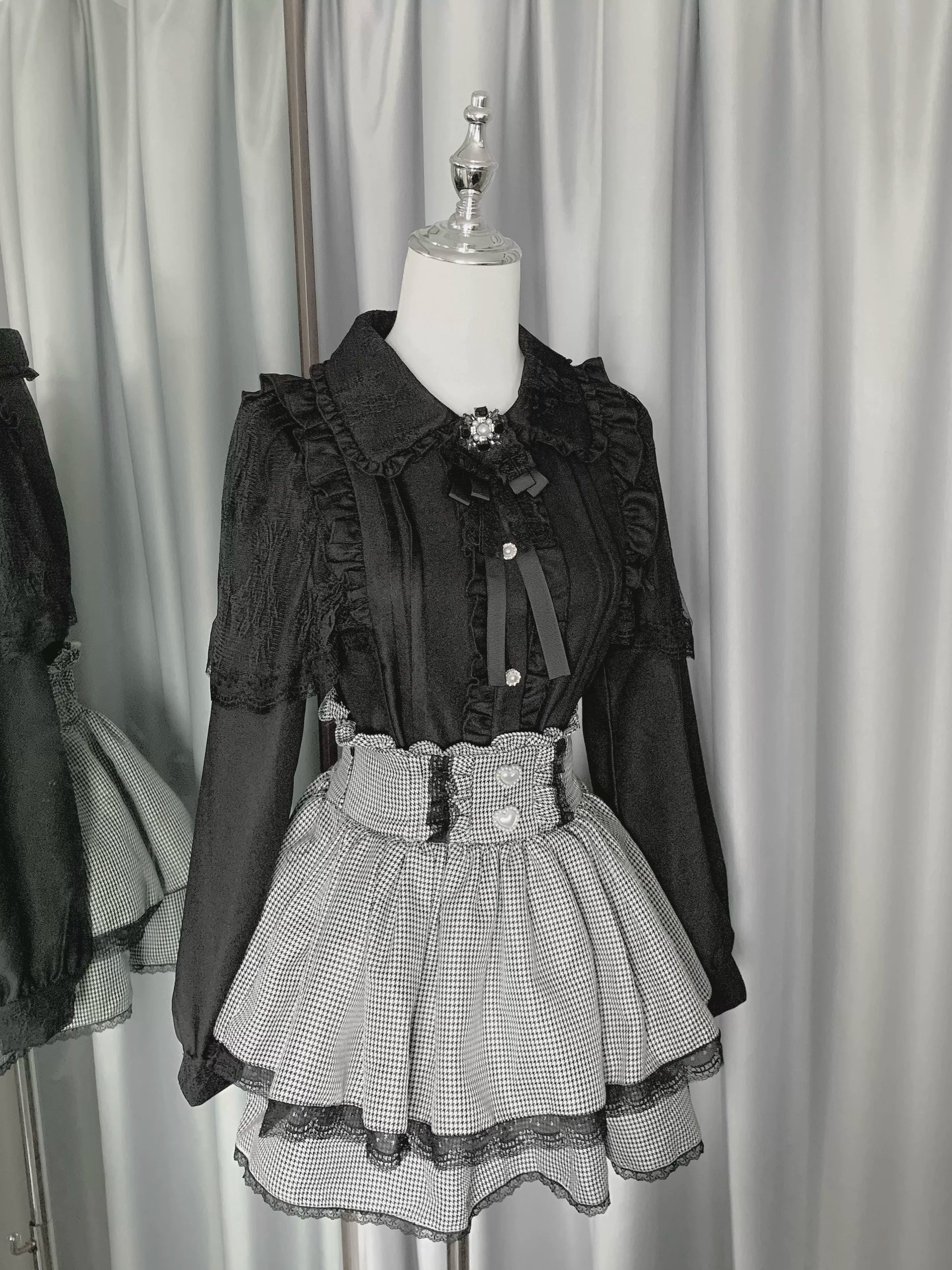 Jirai Kei plaid tiered ruffle skirt with lace trim displayed on mannequin front view gothic aesthetic