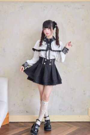 Full-body side view of black high-waisted ryousangata double-layered tweed jirai kei skirt with decorative details, model wearing twin-tail hairstyle in indoor setting