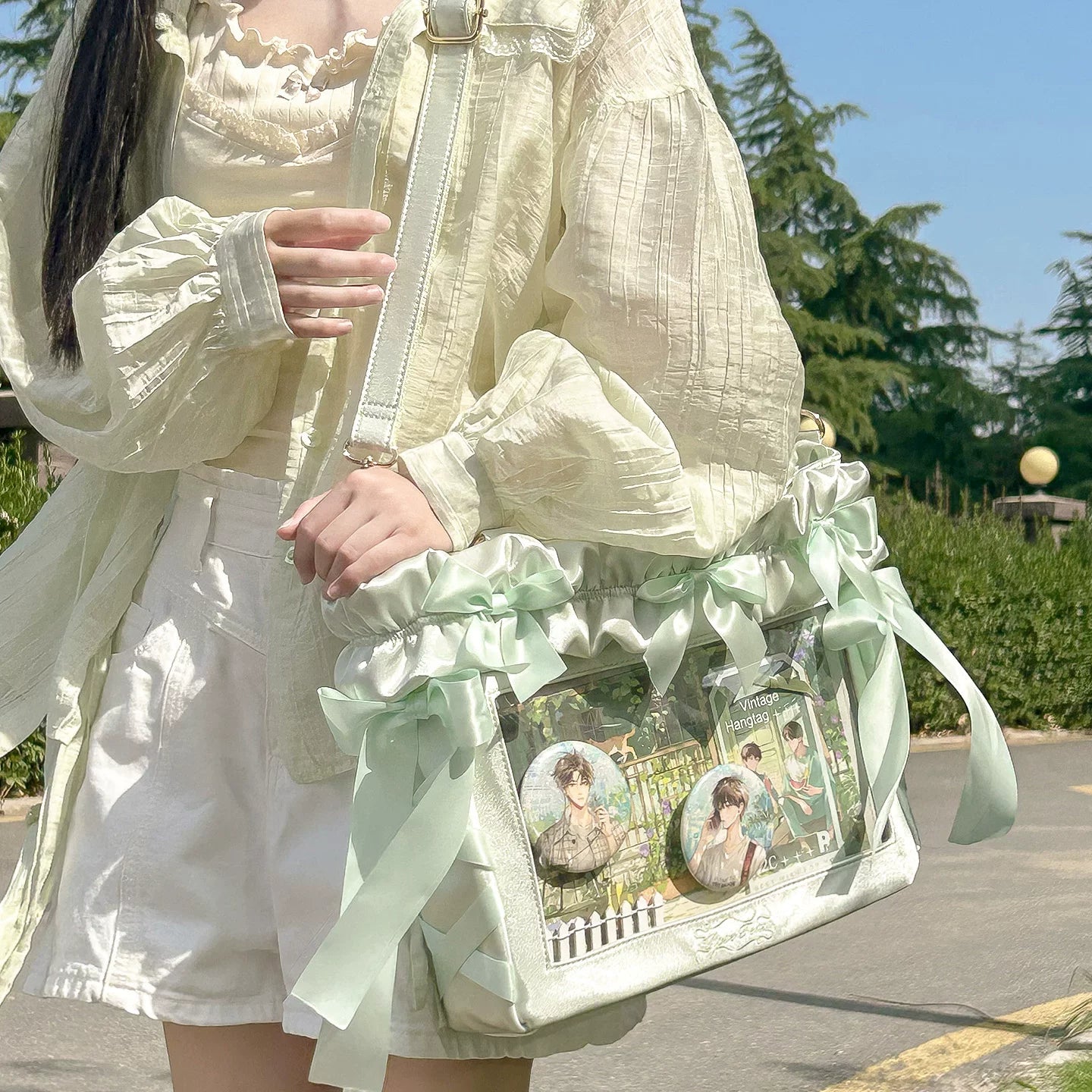Mint chocolate Jirai Kei itabag detail shot showing satin ribbon bow stitching quality ruffles and transparent window clarity