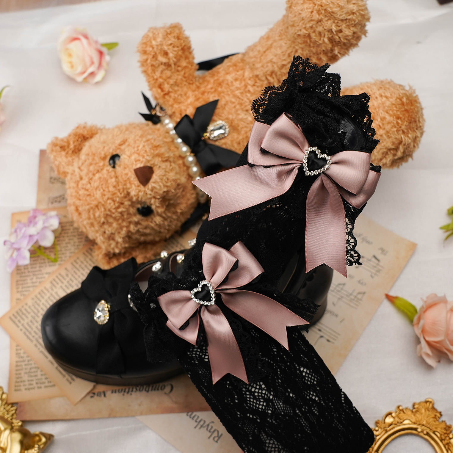 Detailed close-up of jirai kei lace sock texture showing heart-shaped rhinestone placement satin bow construction and delicate lace fabric quality