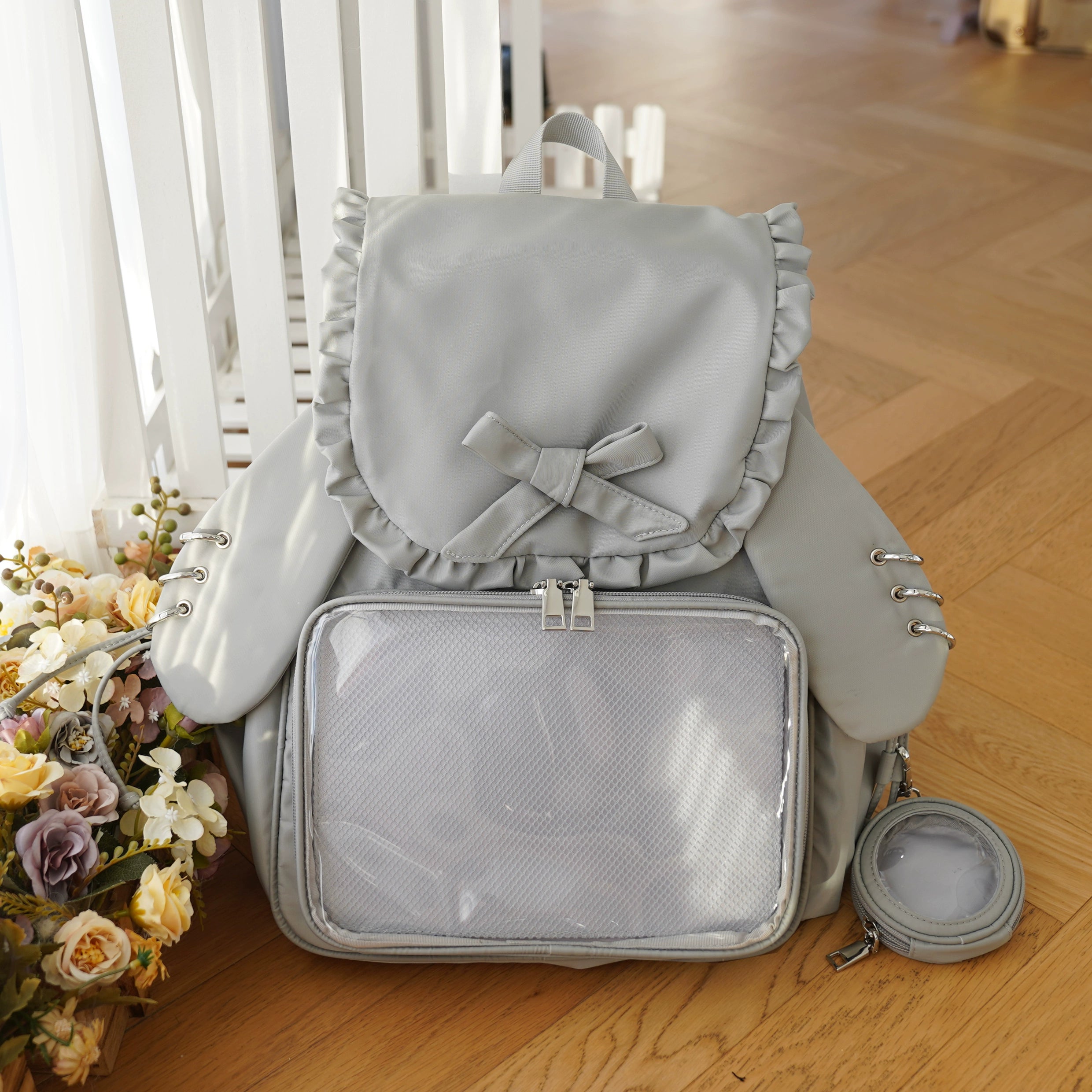 Light grey Jirai Kei bunny ear itabag with transparent display window, ruffled butterfly bow decoration, and grey matching mini bag
