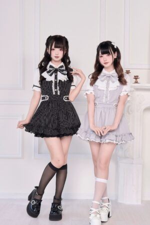 Jirai Kei maid dress collection group shot black striped and gray solid variants on models indoor vintage setting