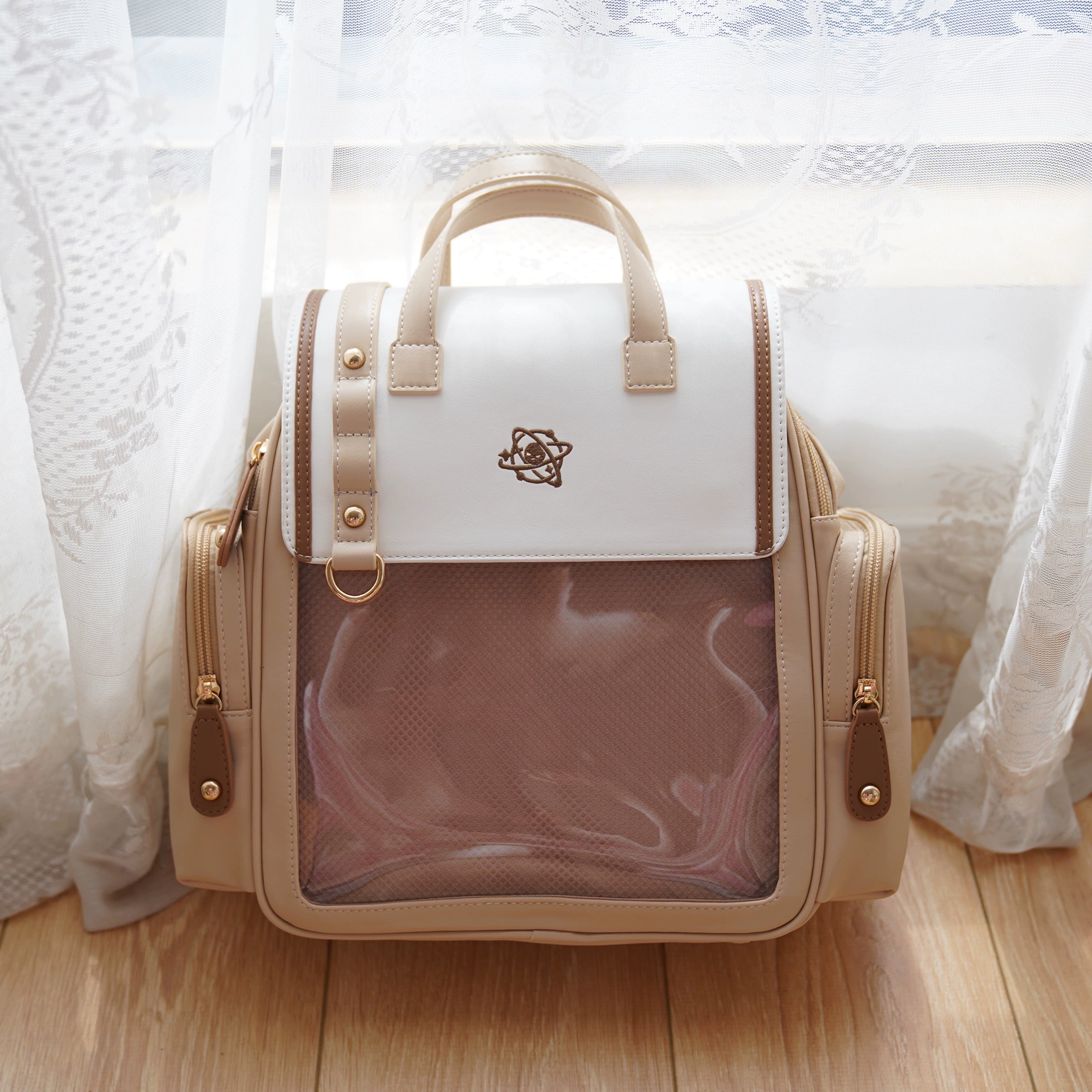 Khaki yellow itabag backpack flat lay frontal view with transparent display window on wooden floor background