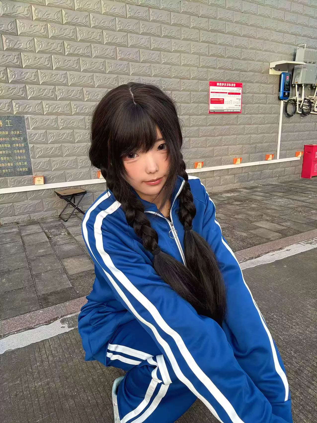 Complete royal blue Jirai Kei tracksuit set jacket and pants matching white stripes outdoor factory area model