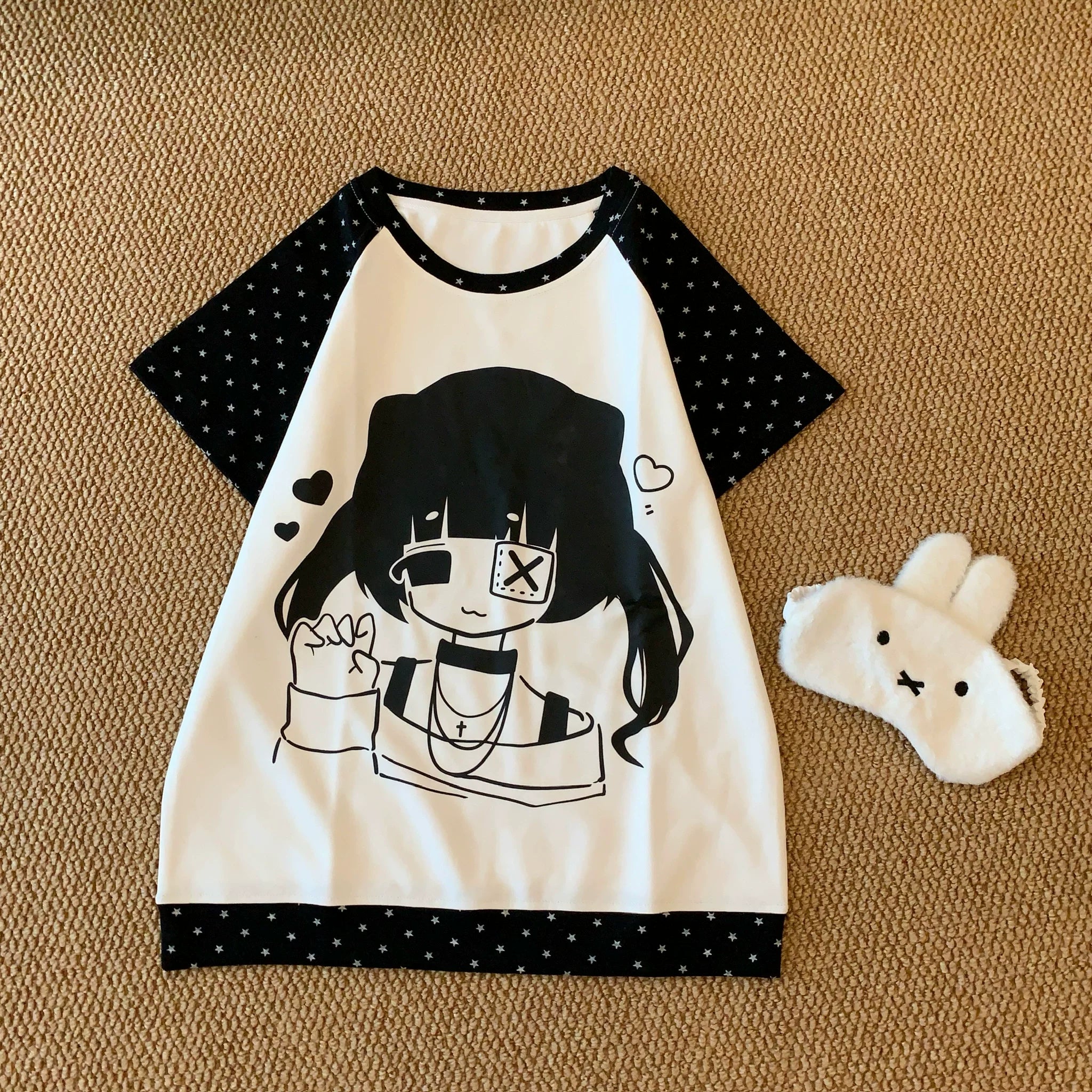 Black and white raglan t-shirt with kawaii anime girl and star print flat lay front showing monochromatic design details