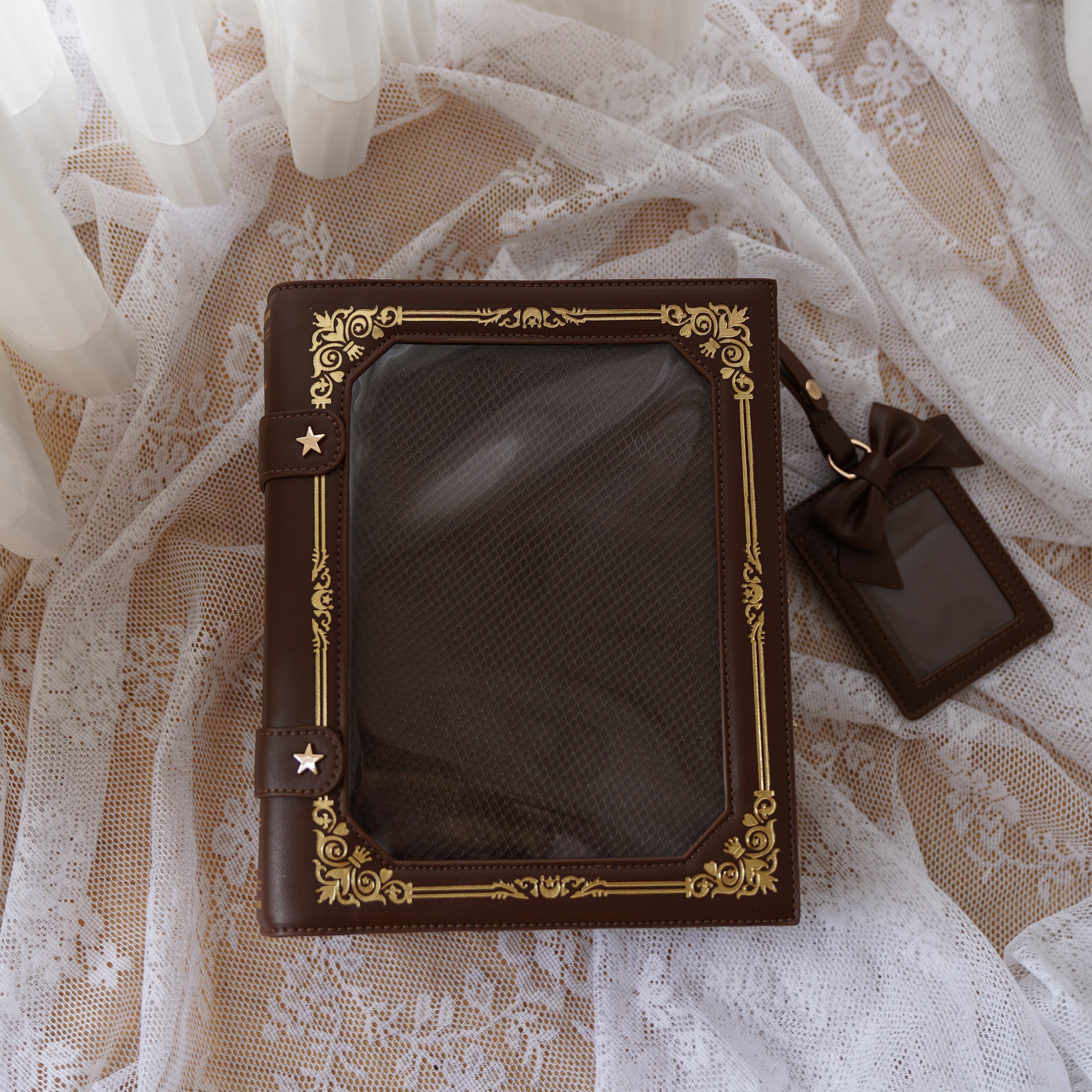 Dark brown vintage grimoire Jirai Kei ita crossbody bag with gold antique border star fasteners flat lay