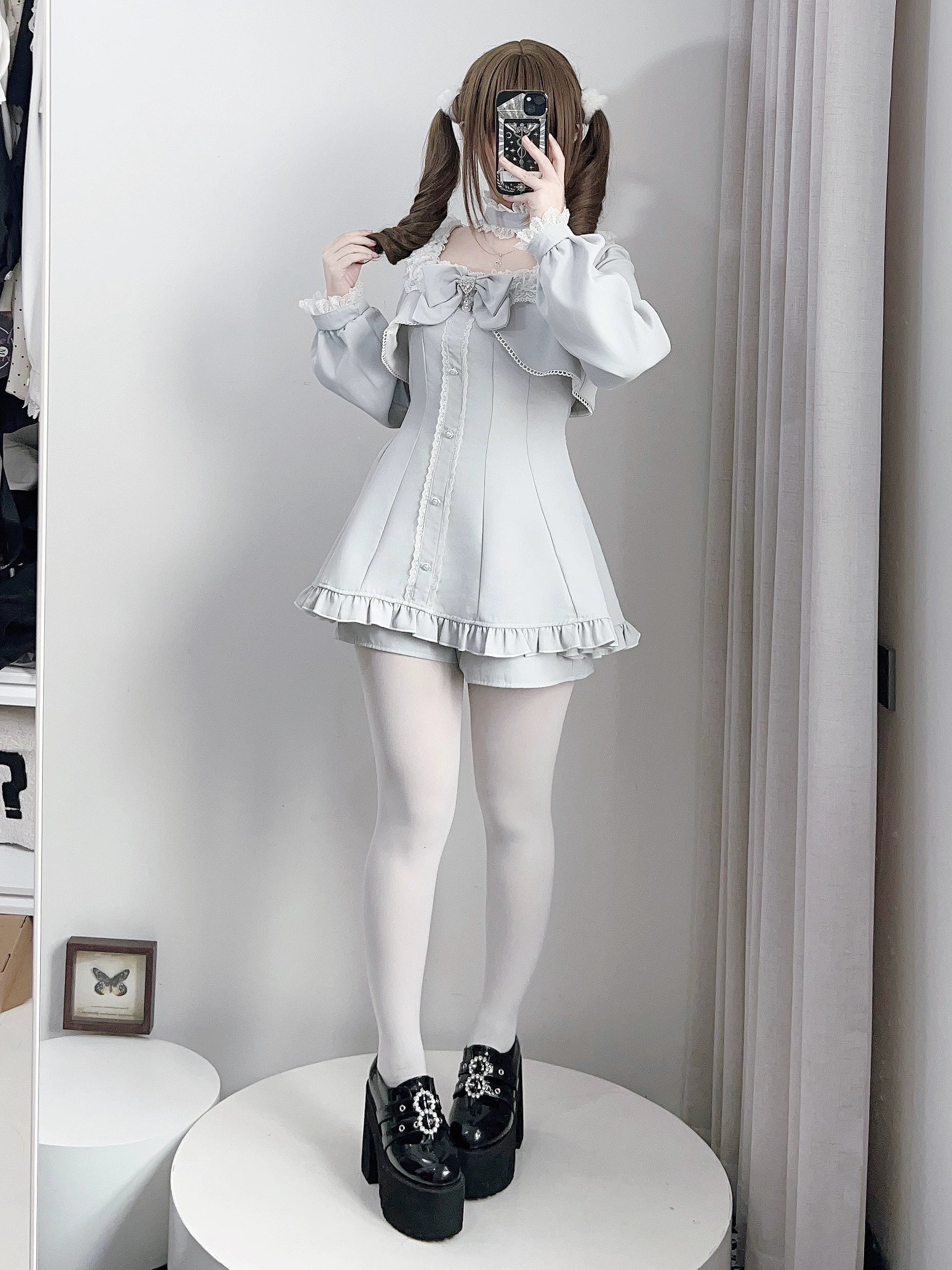 Complete Jirai Kei ensemble including long-sleeve lace dress, pocketed shorts, removable chest bow and choker necklace on mannequin display