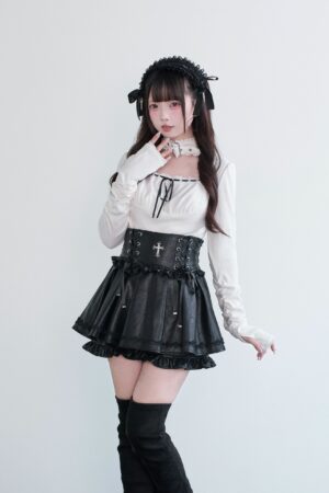Jirai Kei white long-sleeve choker blouse with synthetic leather high-waist skort, ruffled hem, cross waist ornament, front view on model