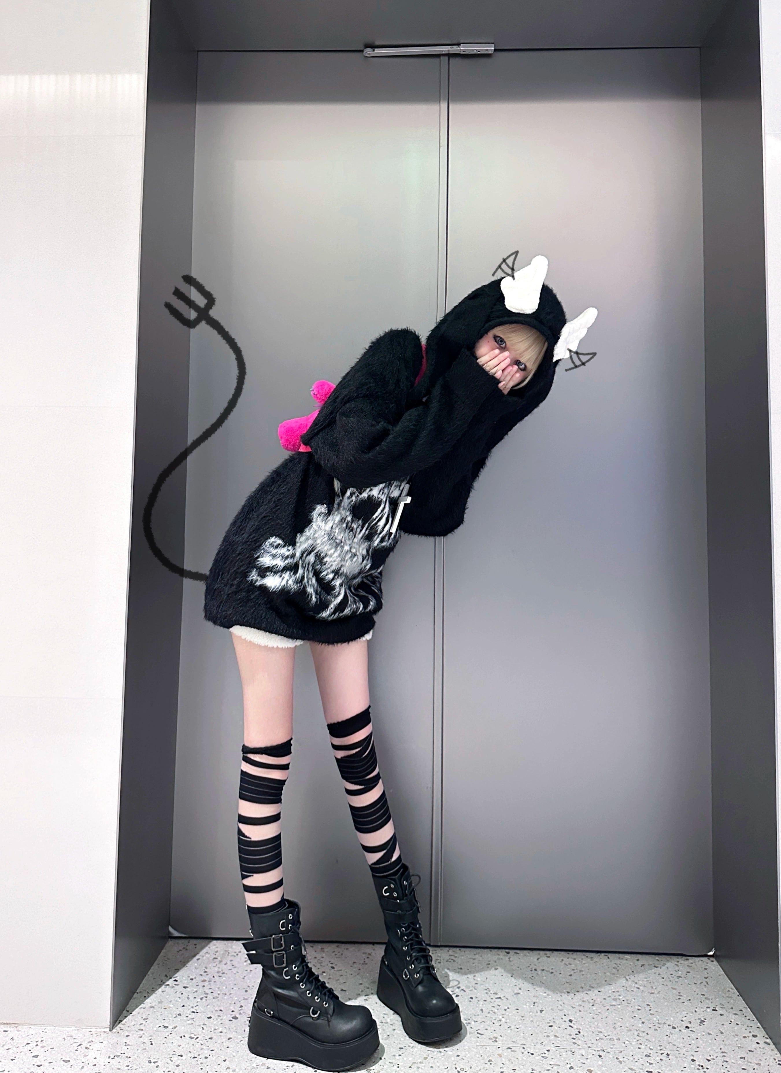 Black fuzzy hooded sweater dress low angle side view jirai kei with devil tail prop fake tail styling platform boots elevator