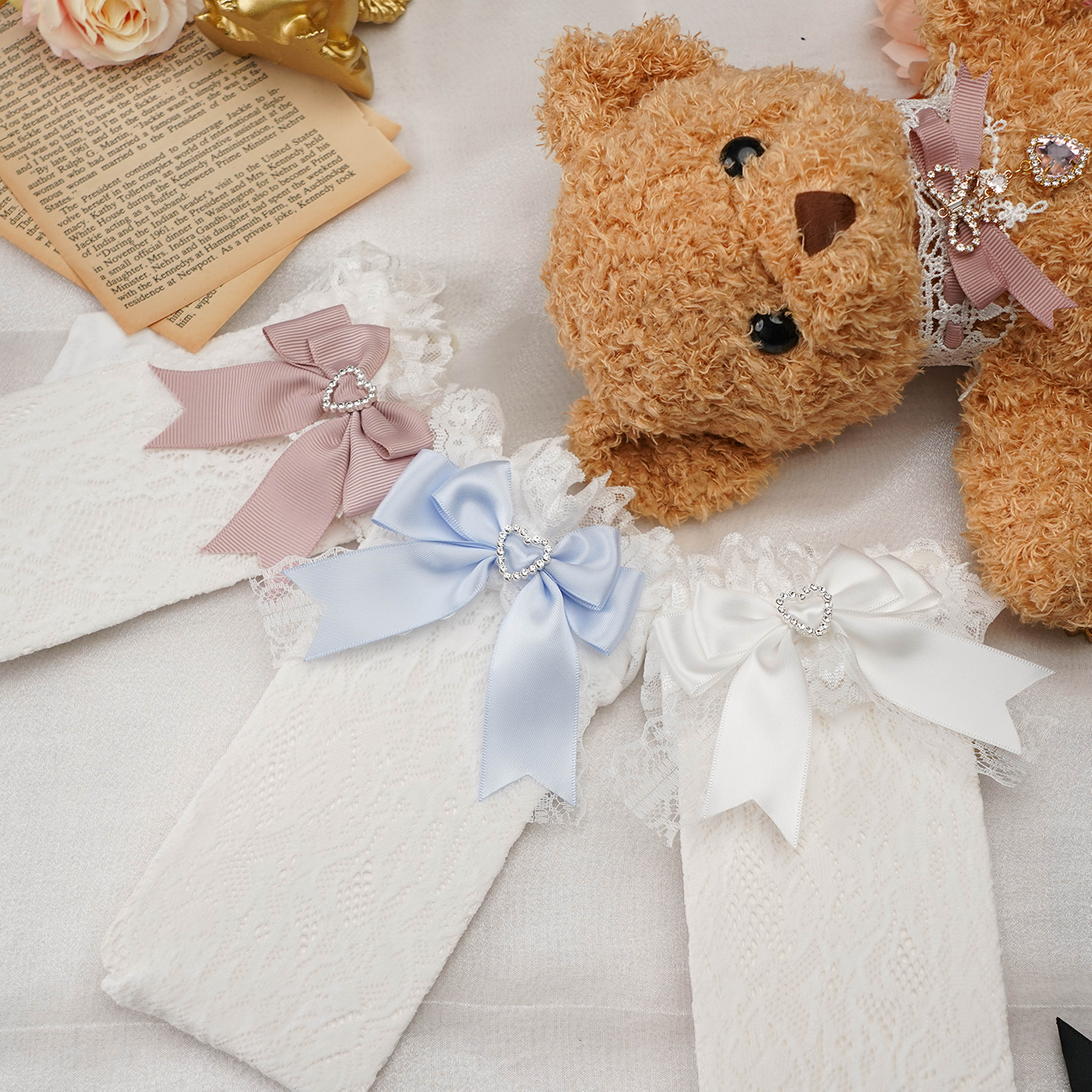 Premium jirai kei lace socks with heart-shaped rhinestones and decorative satin bows showcasing multiple color options and ruffled cuff design