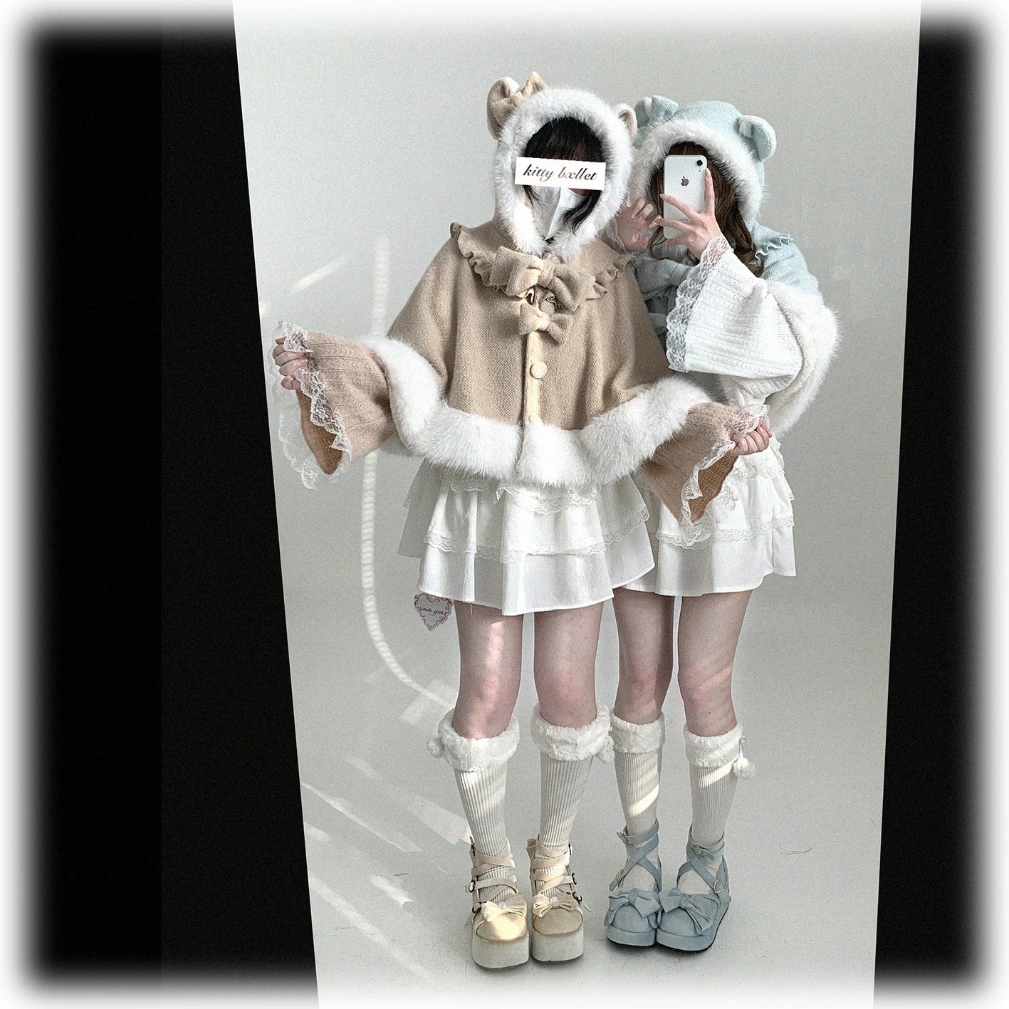 Cat-ear hooded cape detailed product shot emphasizing hood construction, fuzzy white trim border, and playful feline silhouette design elements
