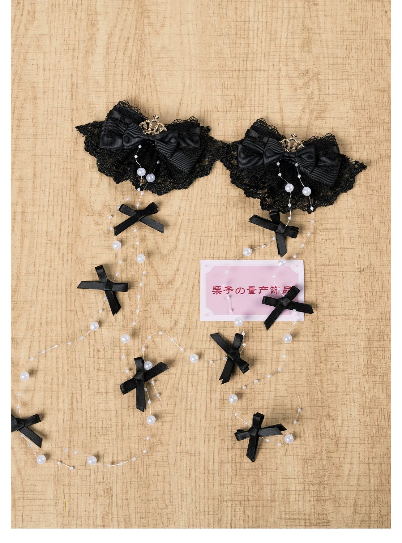 All-black gothic Jirai Kei hair clip with black lace bow, rhinestone crown decoration, and black cross pearl chain bows