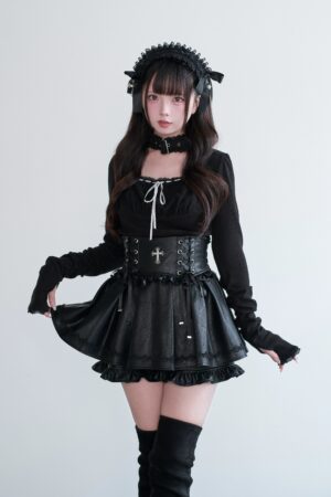 Black square-neck Jirai Kei choker top with lace-up front and high-waisted leather skort, worn with fingerless gloves and cross waist buckle