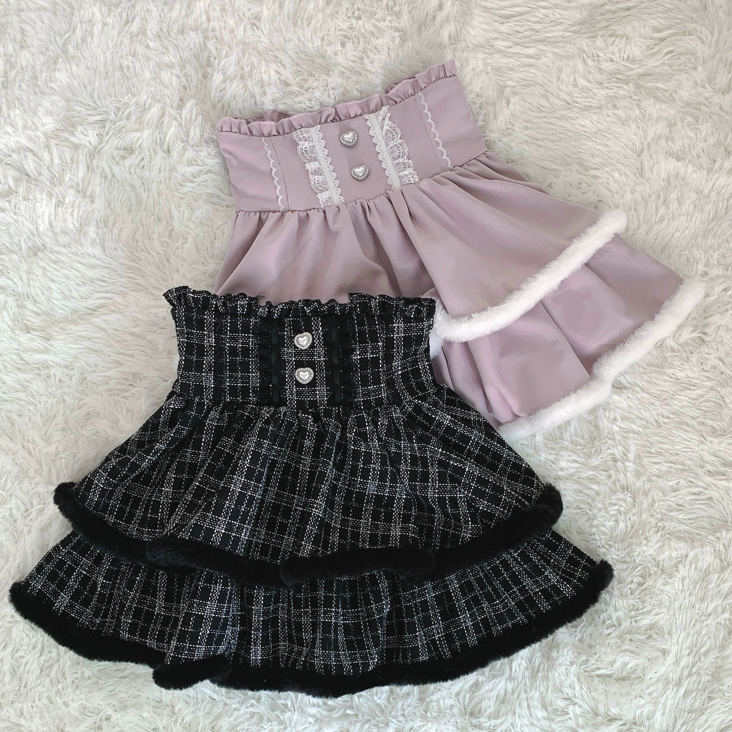 Top down flat lay comparison pink white and black plaid tiered Jirai Kei skirts plush trim high waist design options