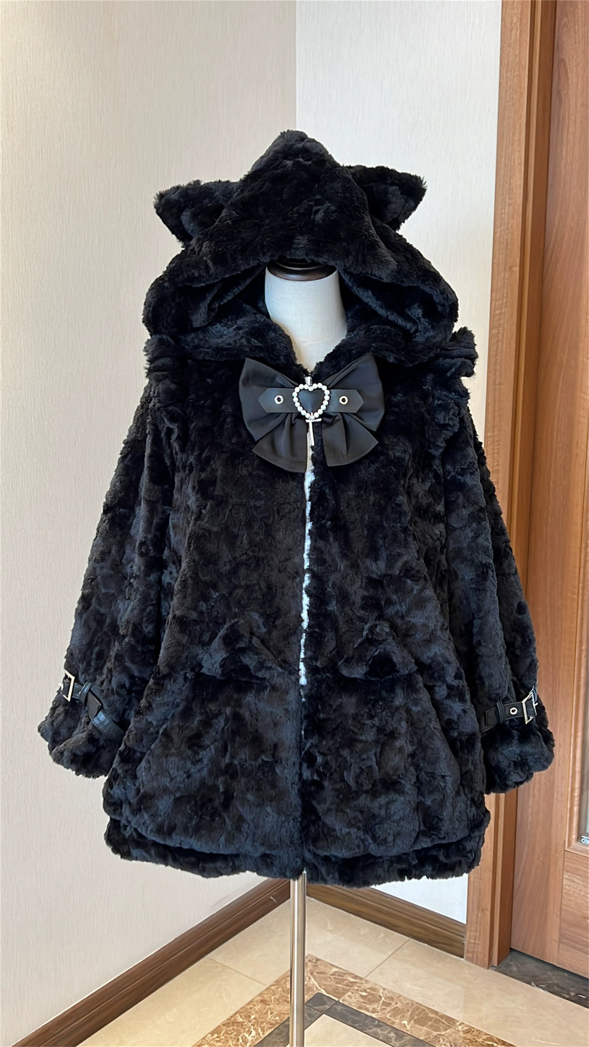 Black plush fleece Jirai Kei coat with cat ear hood, three-quarter angle showing side profile, buckle strap details, and cat ear pocket patches