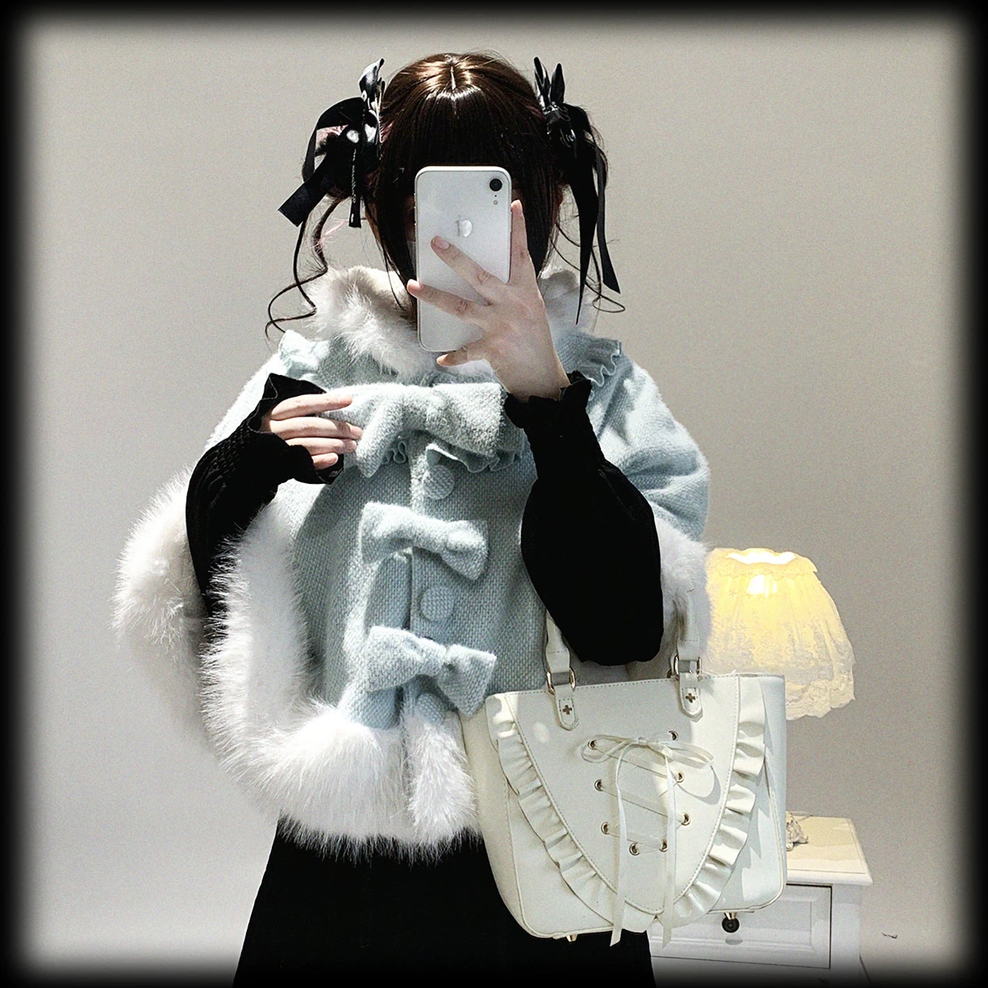 Styled flat lay of cat-ear hooded cape in mint showing folded presentation, bow detail, and how the cape structures with attached hood