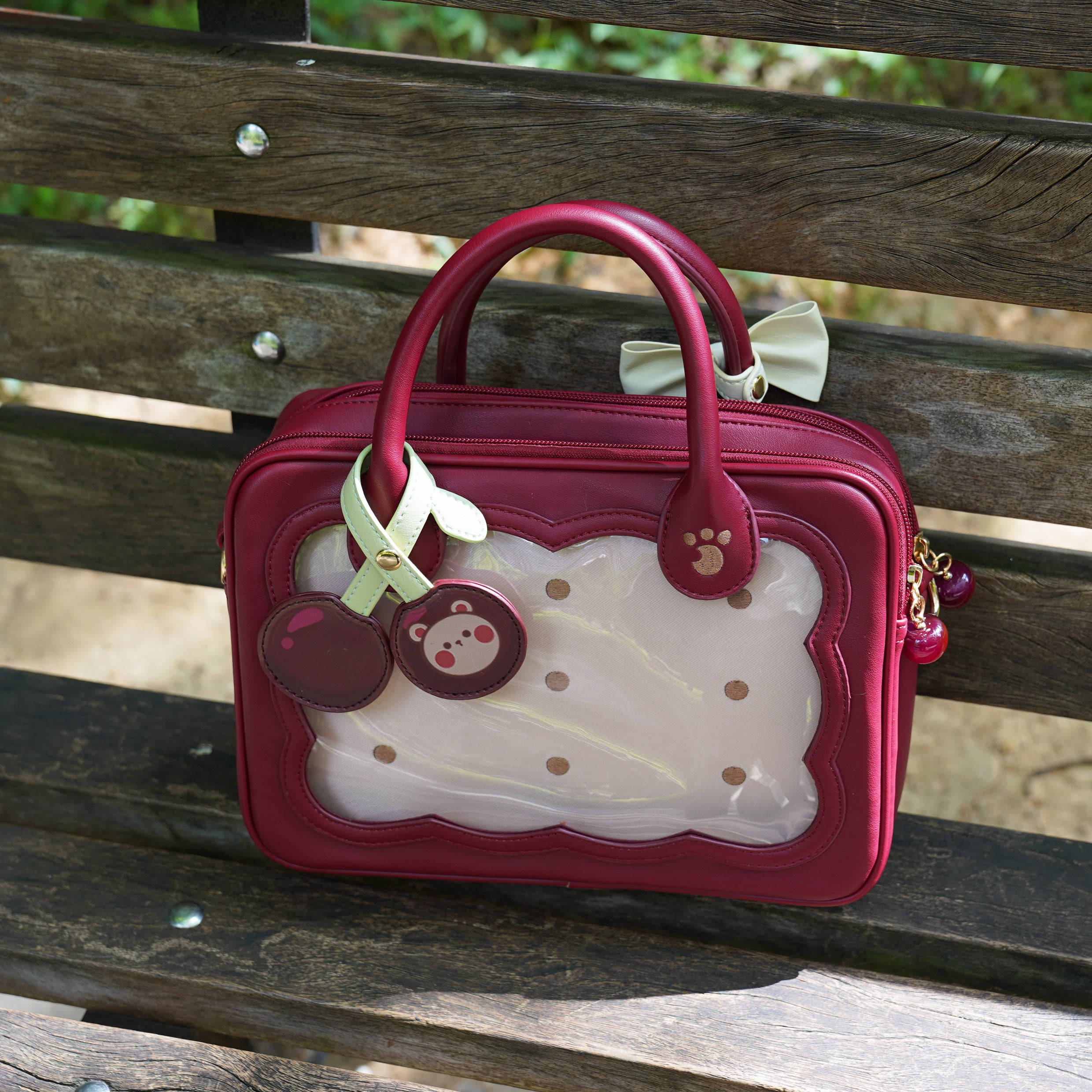 Deep wine red burgundy cherry bear cookie Jirai Kei bag with light green bow strap and side bow accent close-up view