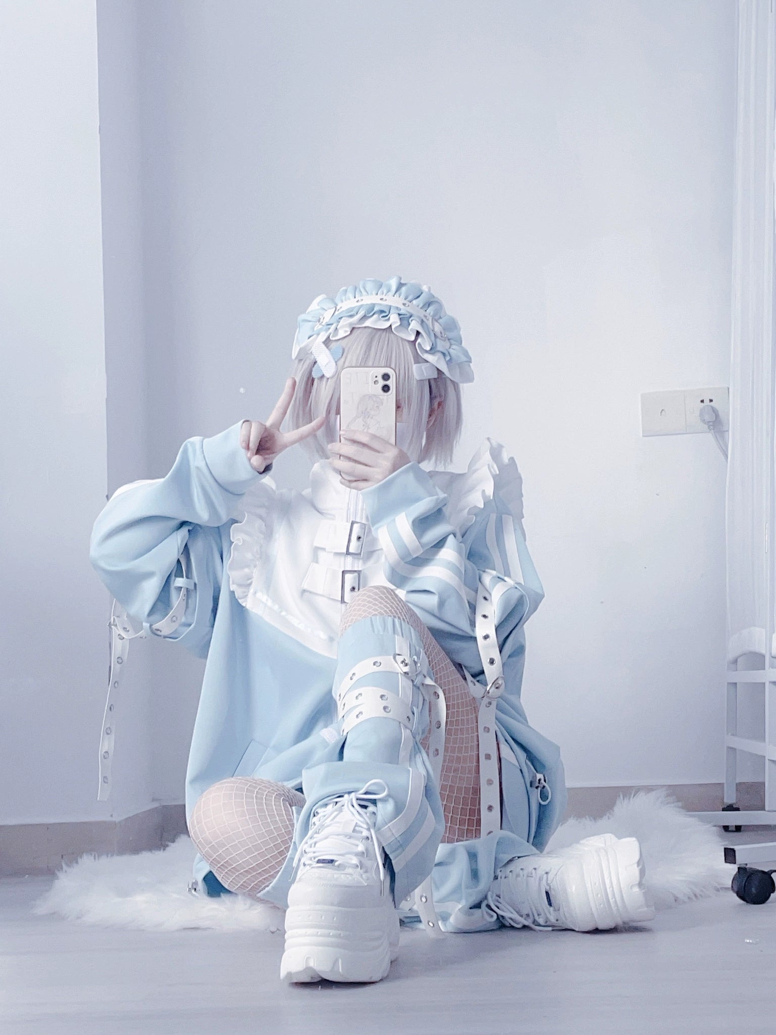 Blue white Y2K jacket detachable sleeves loose fit seated mirror selfie one leg raised model fishnet stockings platform boots fur rug