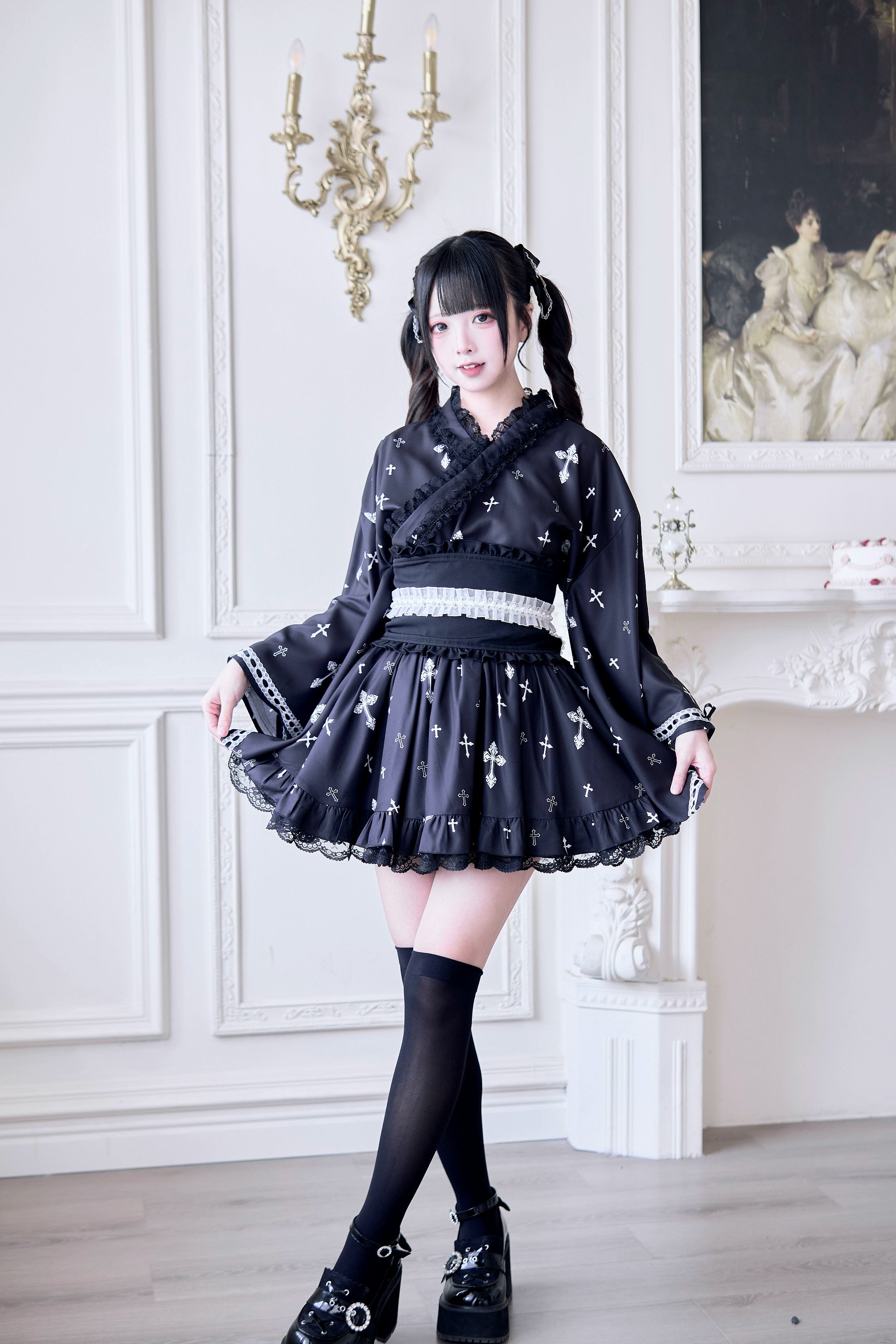 Black Jirai Kei kimono outfit front view with twin-tailed female model wearing wide waist belt, ruffled mini skirt, and cross pattern blouse with lace trim