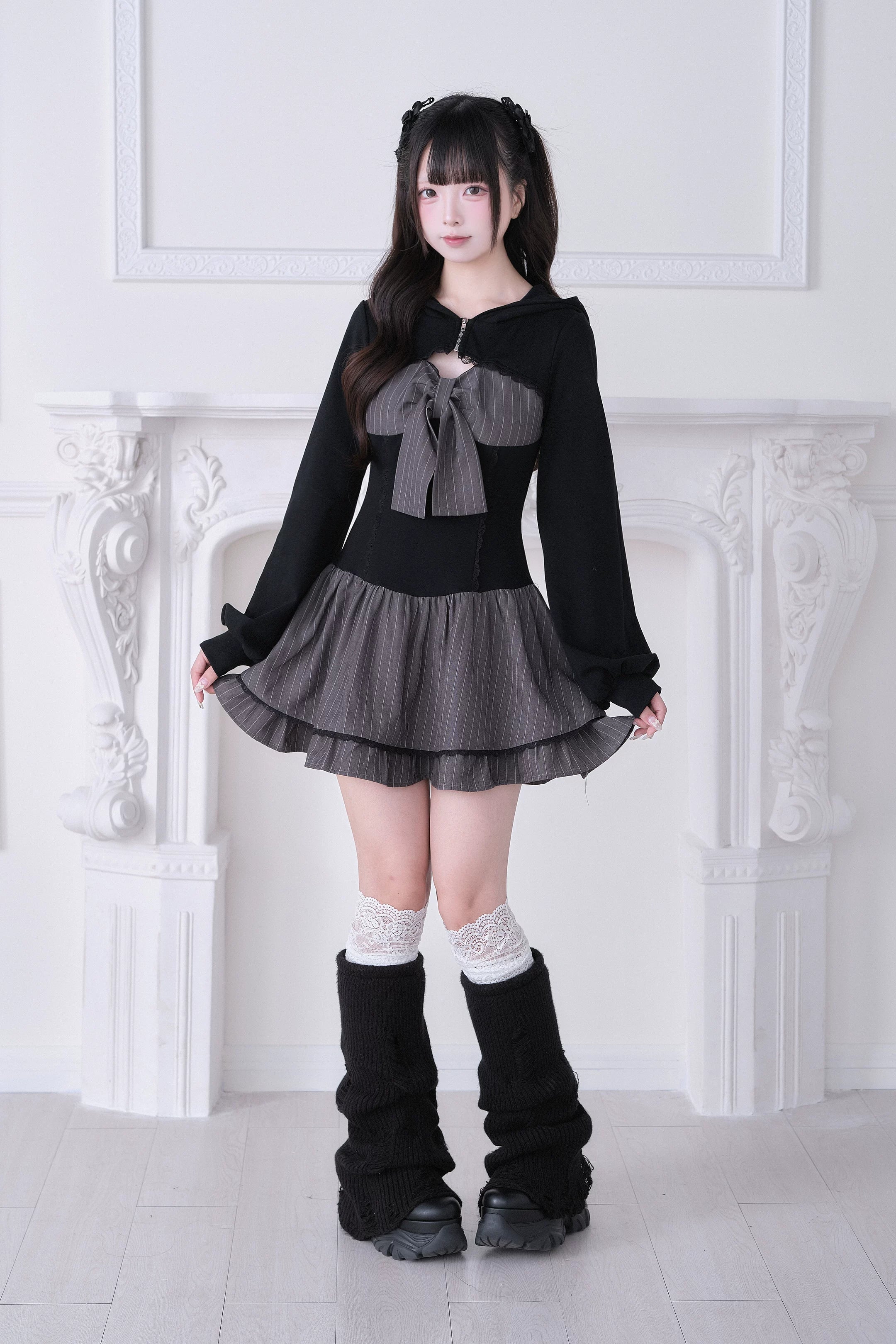 Gray Jirai Kei hoodie dress front view with solid grey bow, ruffled skirt and black leg warmers on model with twin tails