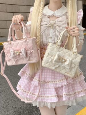 Ryousangata square quilted handbag in pink with lace bow and rhinestone details, worn by model in Lolita dress, front view