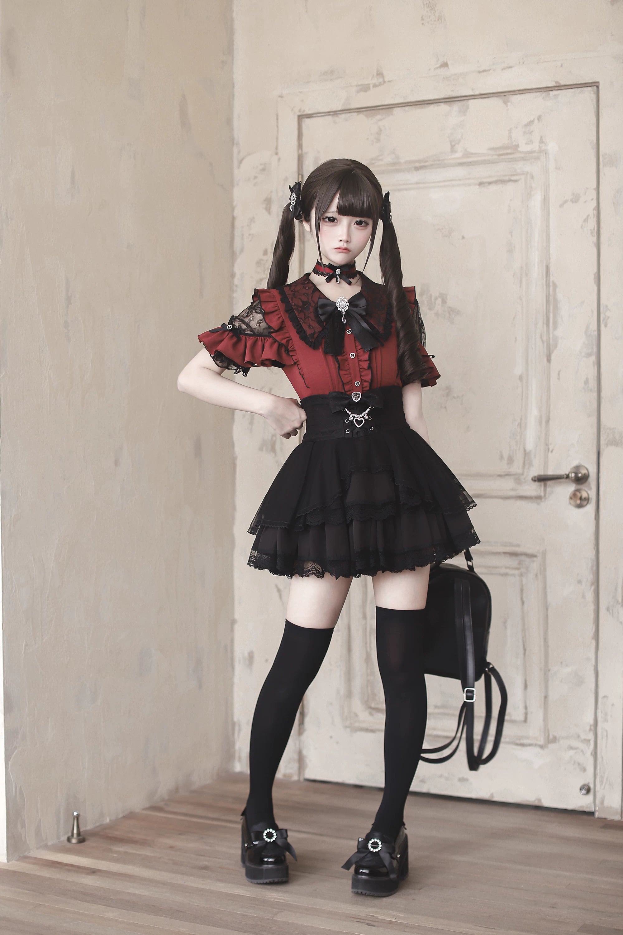 Red and black Jirai Kei blouse with structured crossbody bag matching black loafers high-waisted skirt