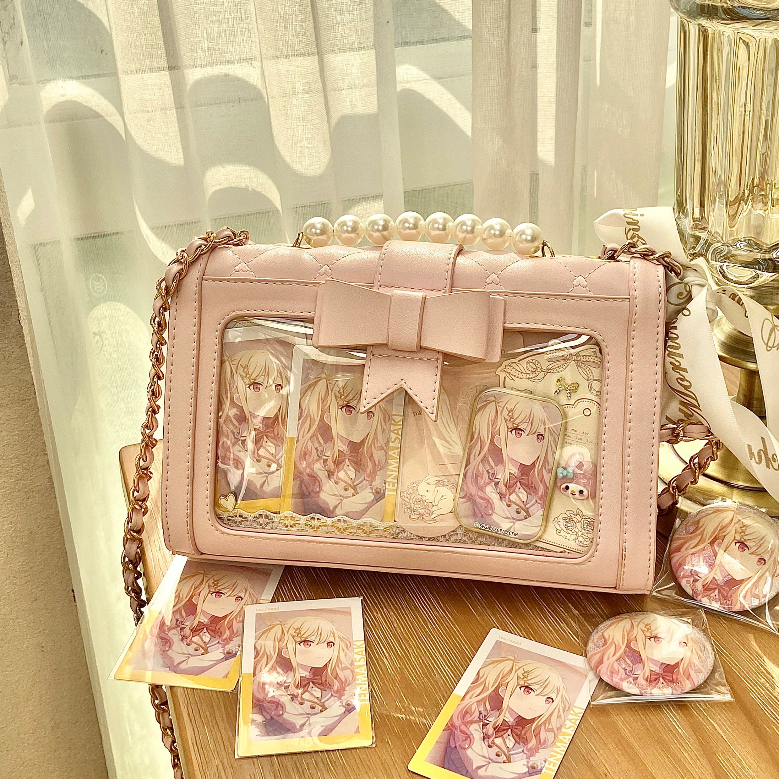 Pink jirai kei ita shoulder bag featuring full rhombus quilting and transparent compartment for collectible pins